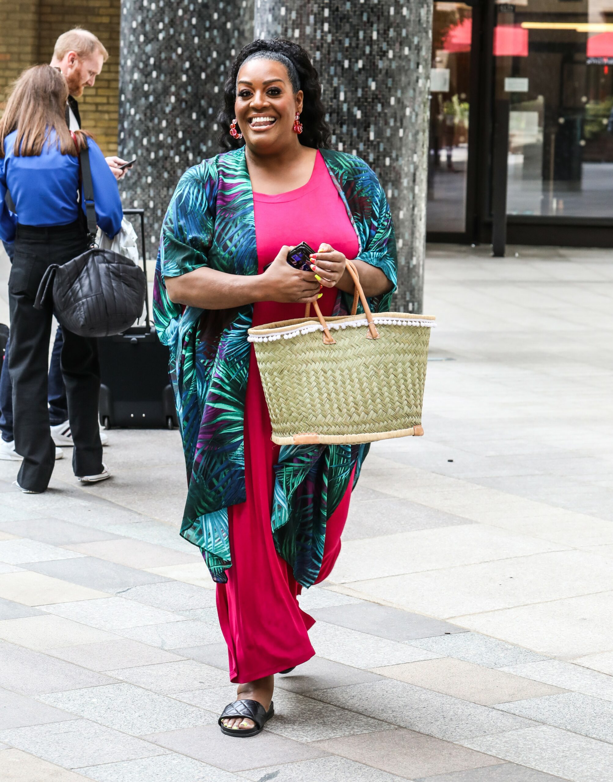 Alison Hammond smiles in pink and blue outfit outside ITV studios