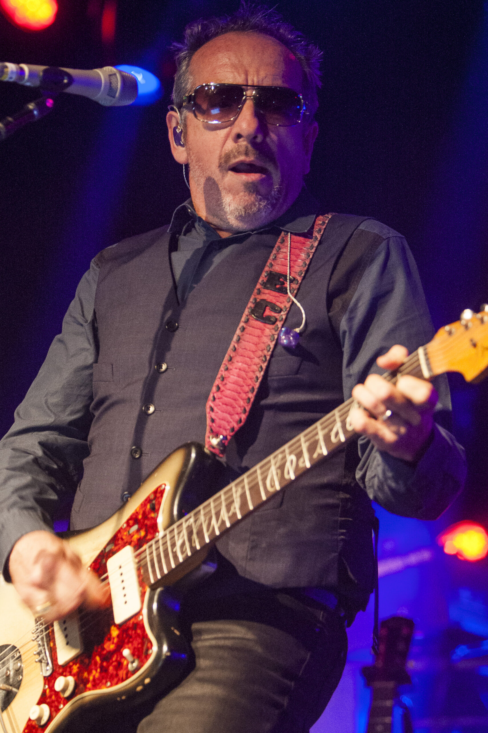 Elvis Costello on stage with his guitar