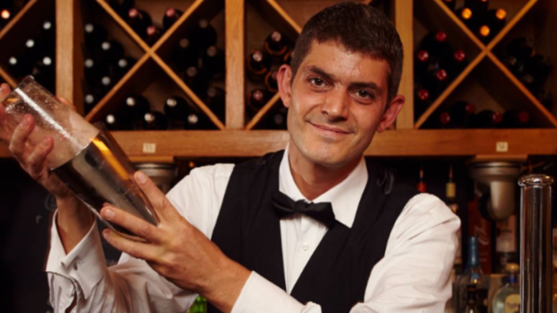 First Dates' Merlin preparing a drink behind the bar
