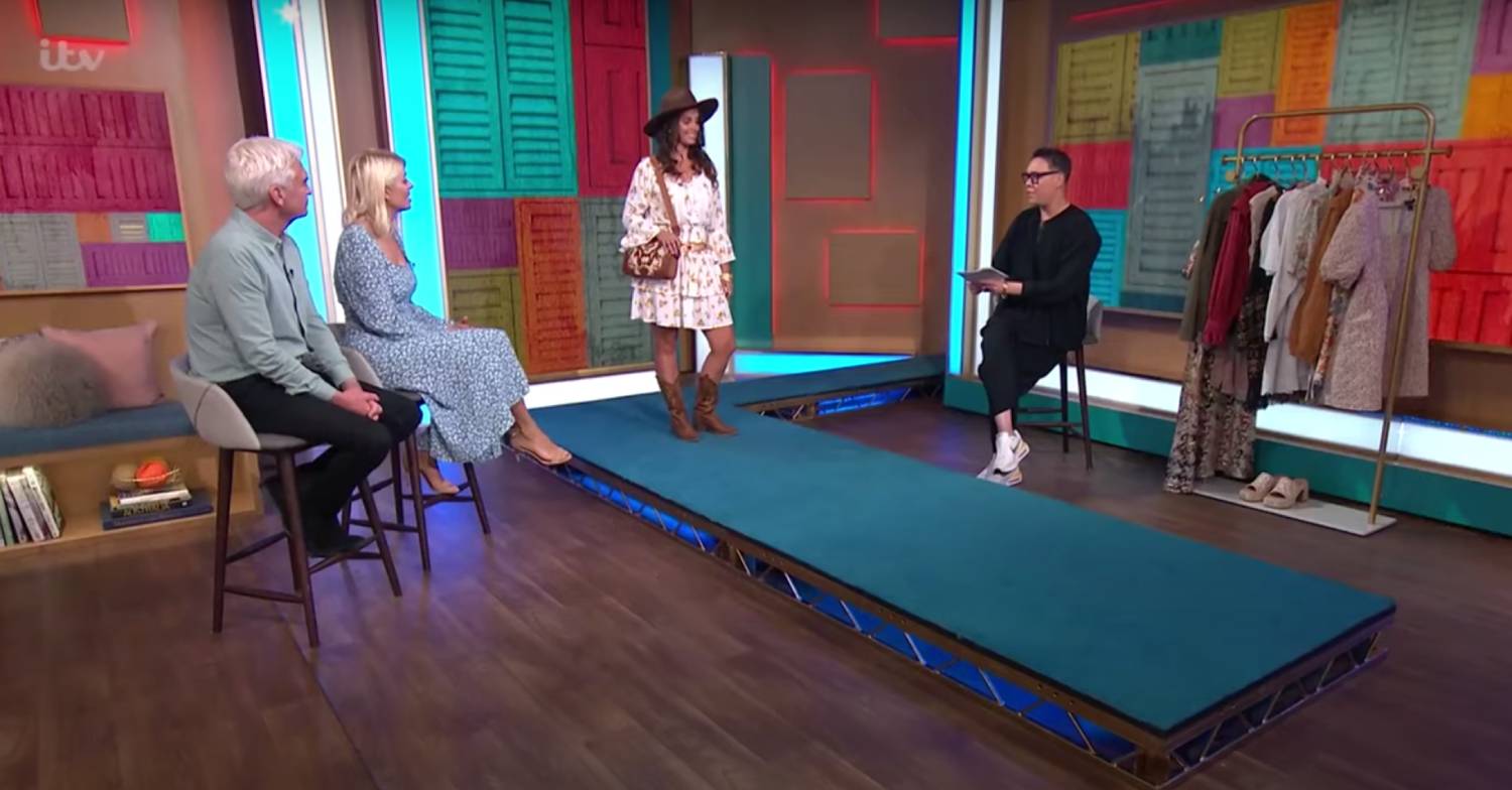 Holly Willoughby observes the fashion segment on This Morning in blue floral dress today