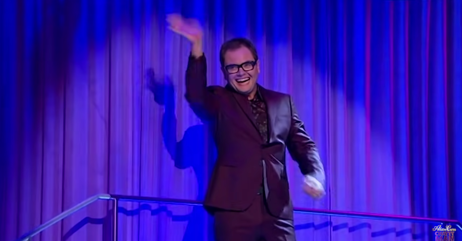 Alan Carr waves to audience