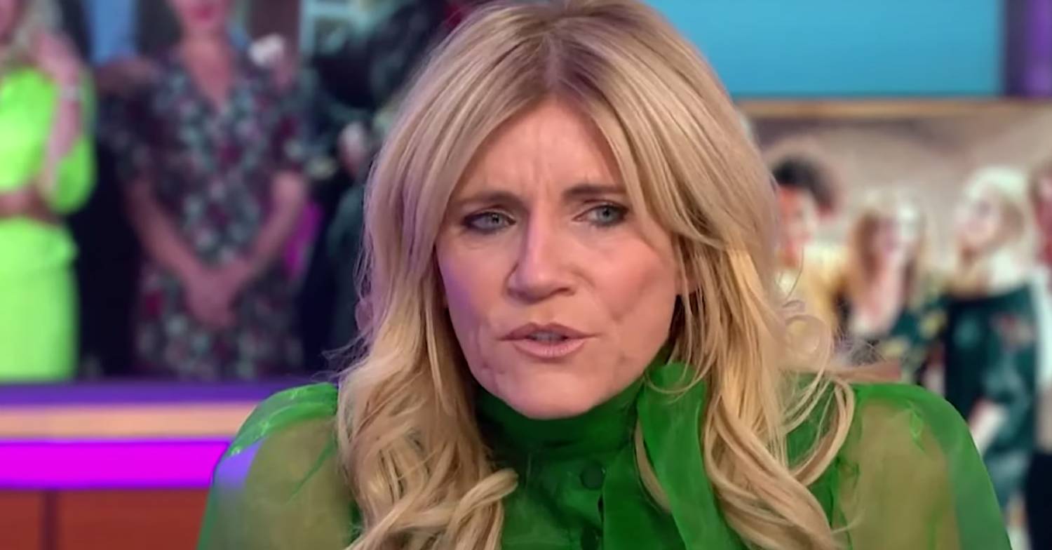 Michelle Collins frowns during a TV interview