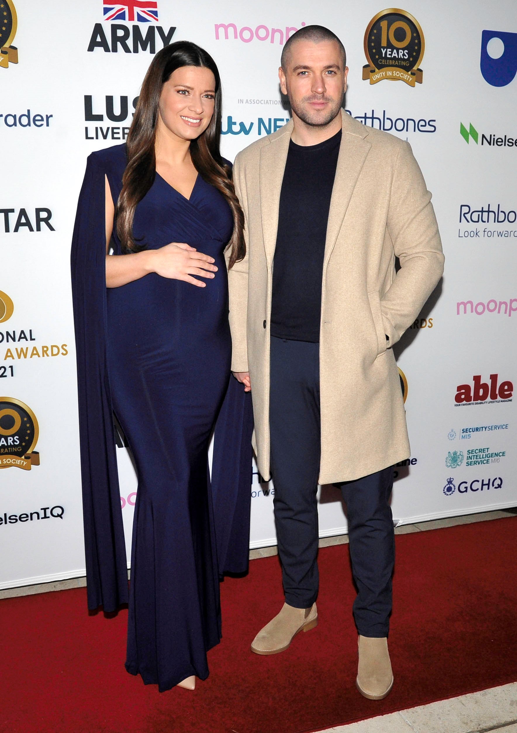 Shayne Ward smiling with Sophie Austin on red carpet