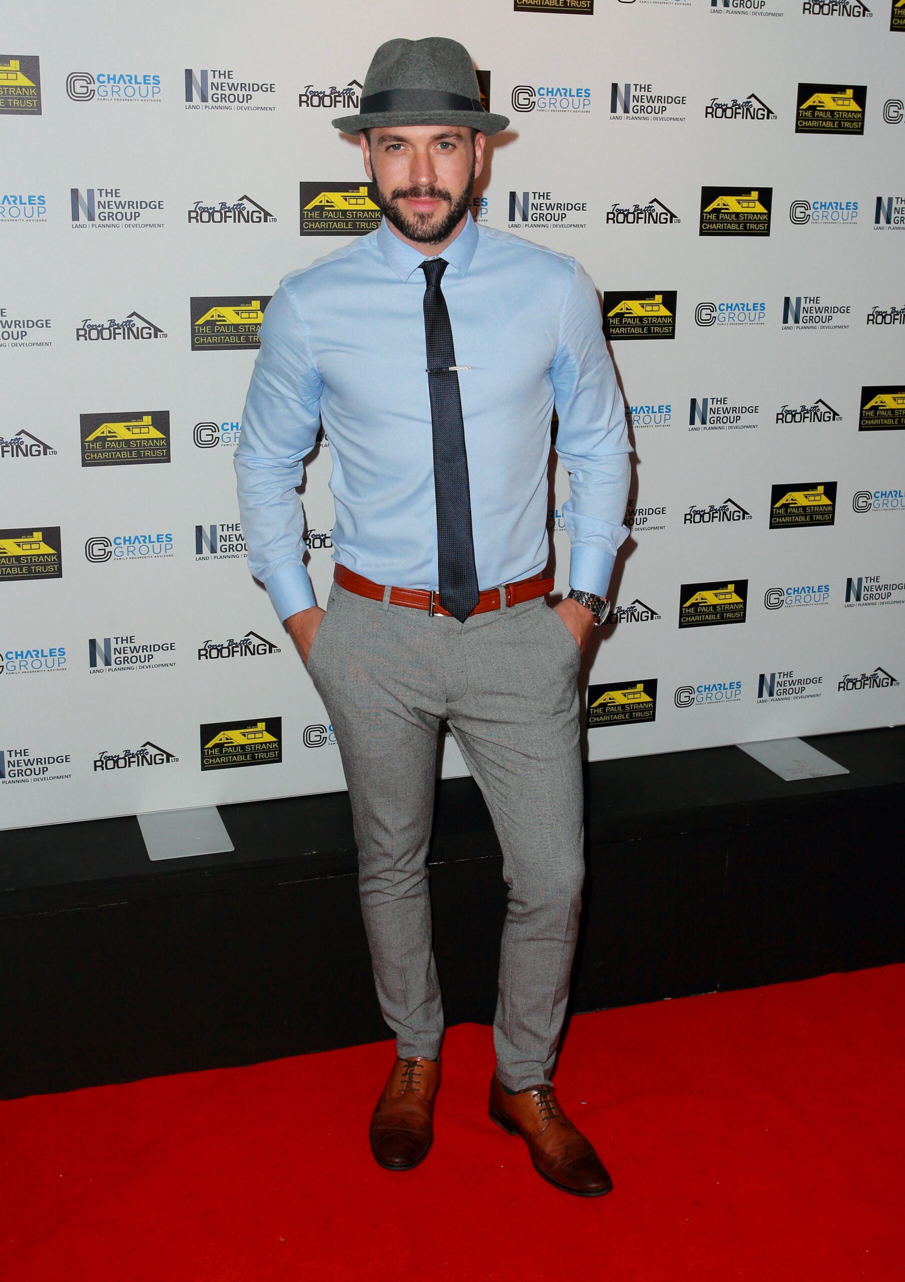 Shayne Ward in hat as he poses on red carpet
