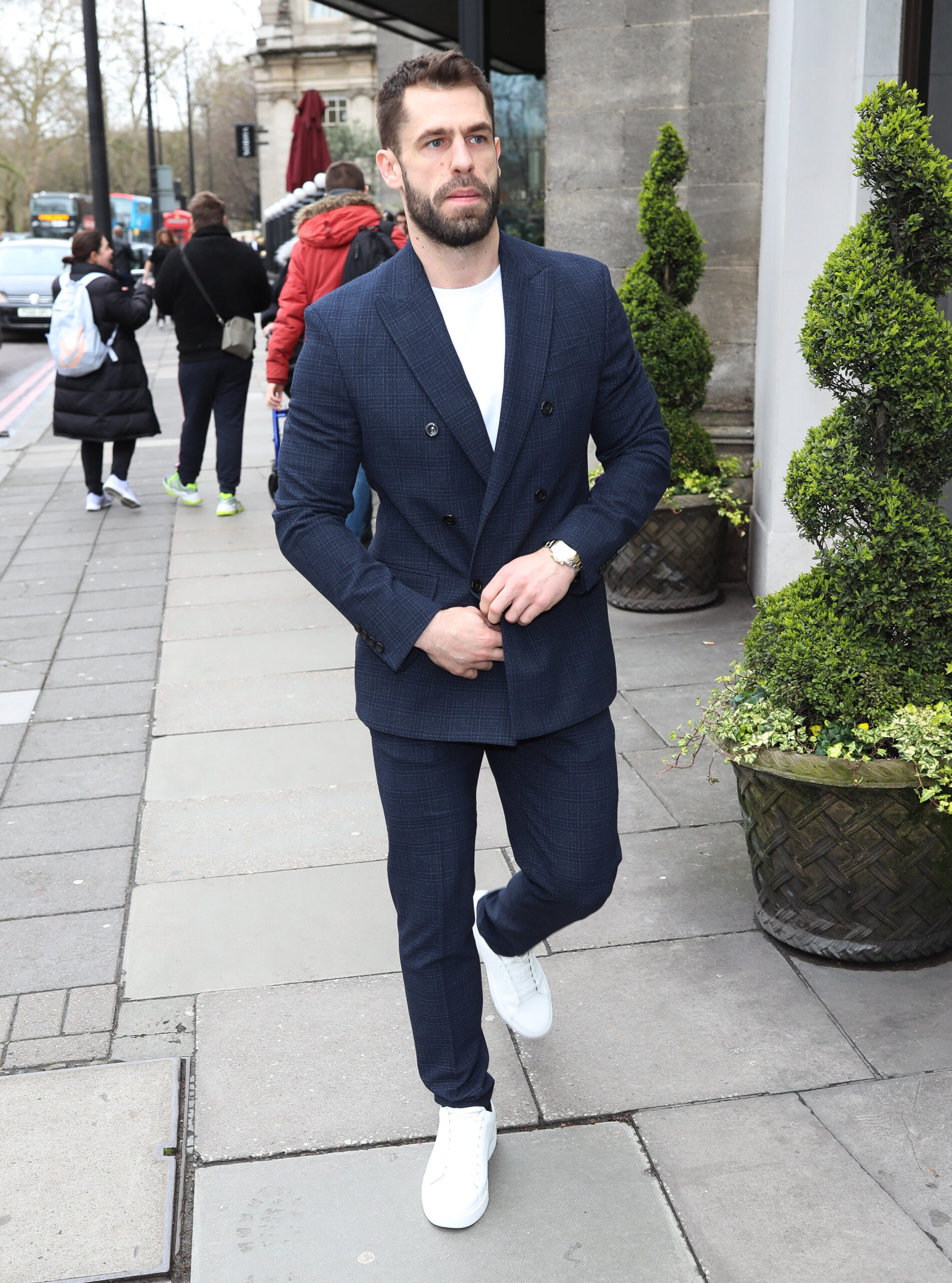 Kelvin Fletcher walking down the street in a navy jacket