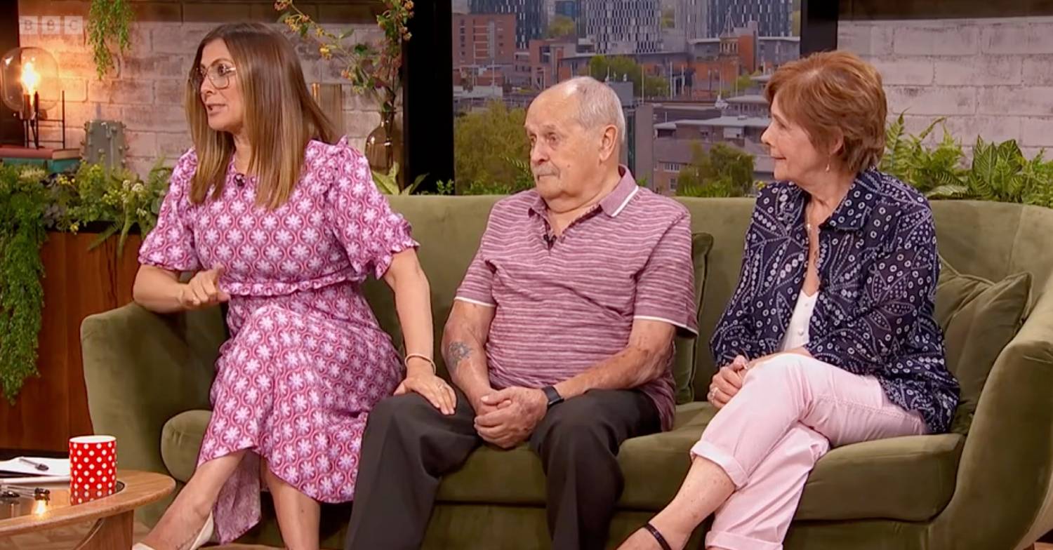 Kym Marsh rests a hand on the leg of her dad