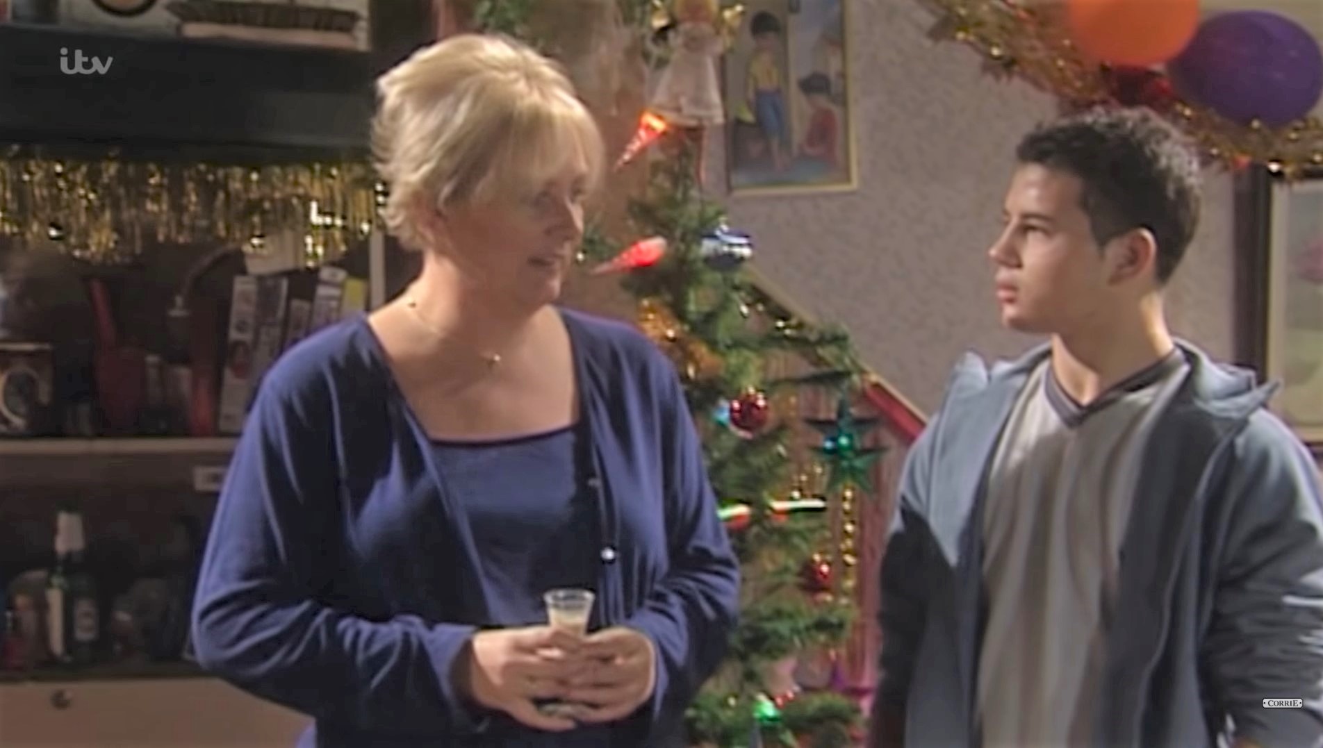 Eileen and Jason Grimshaw in Coronation Street look at each other suspiciously 