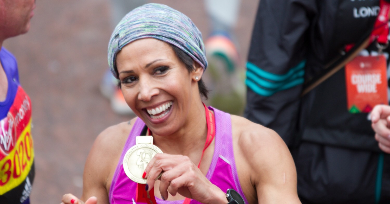  Olympian Kelly Holmes grins as she shows off gold medal