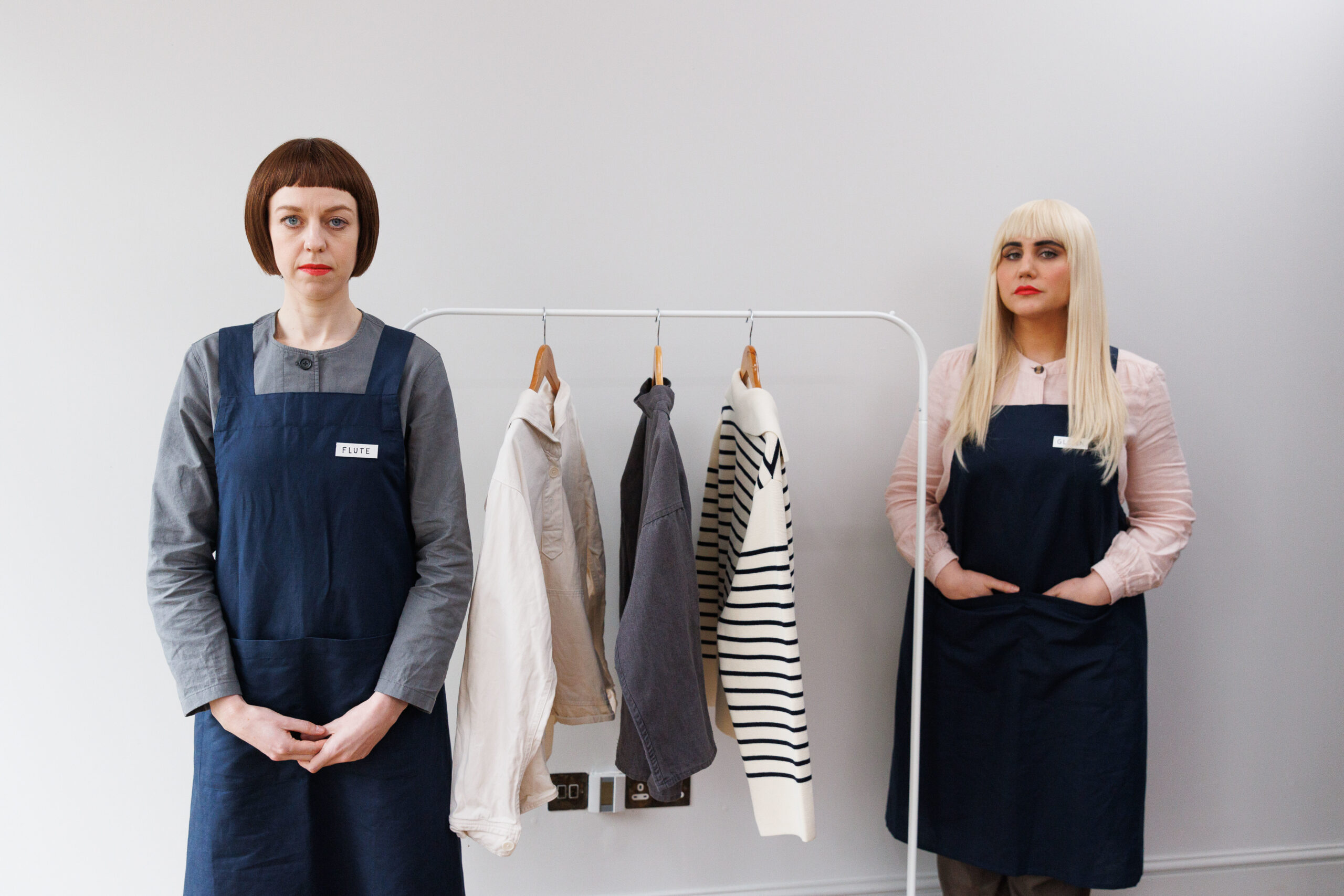 Ellie White and Natasia Demetriou staring blankly at the camera