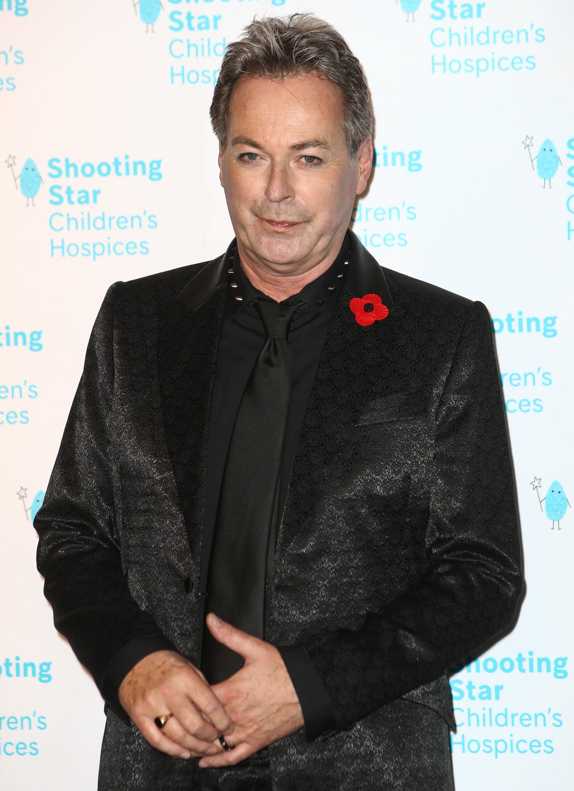 Julian Clary smiles at 2021 Shooting Star Ball Arrivals