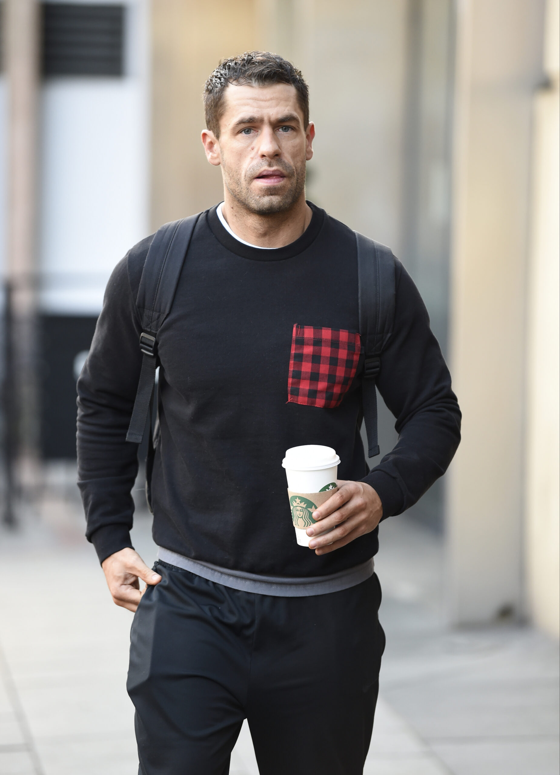 Kelvin Fletcher holding a cup of coffee