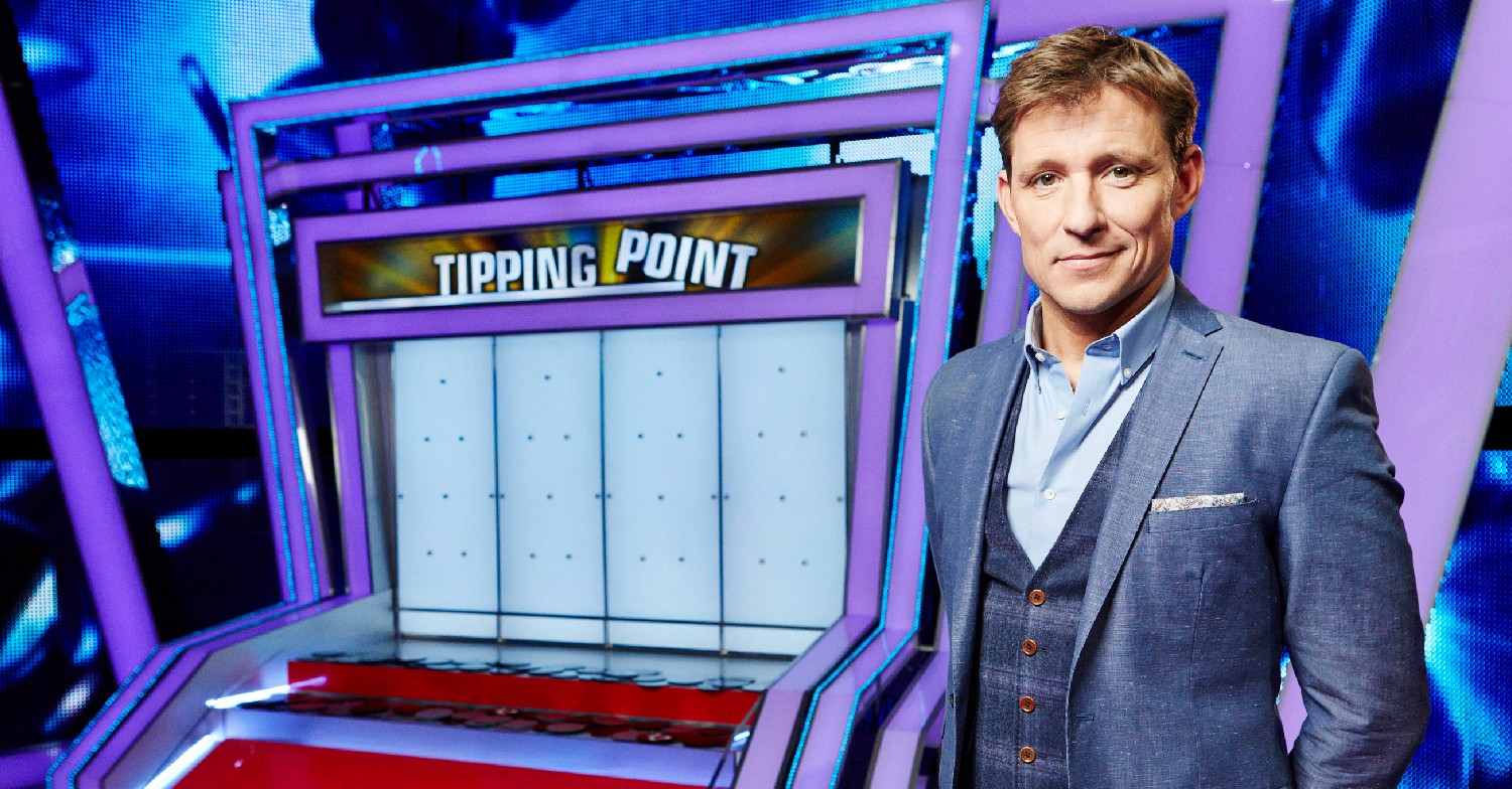 Ben Shephard smiling in front of the Tipping Point machine
