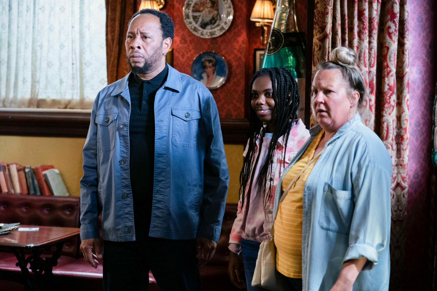 Mitch and Karen look worried as Bailey smiles in EastEnders