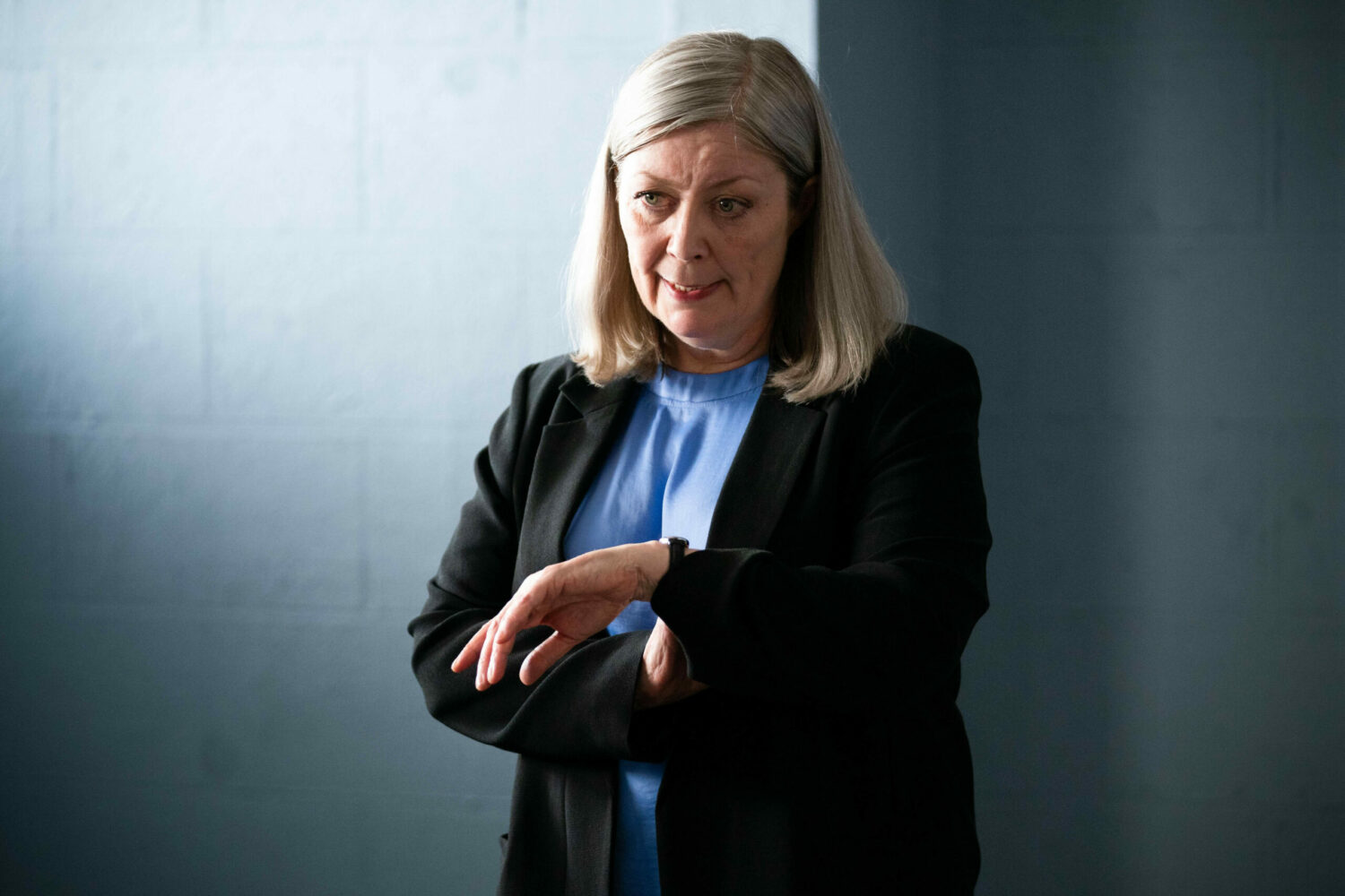 DCI Samantha Keeble looking at her watch EastEnders