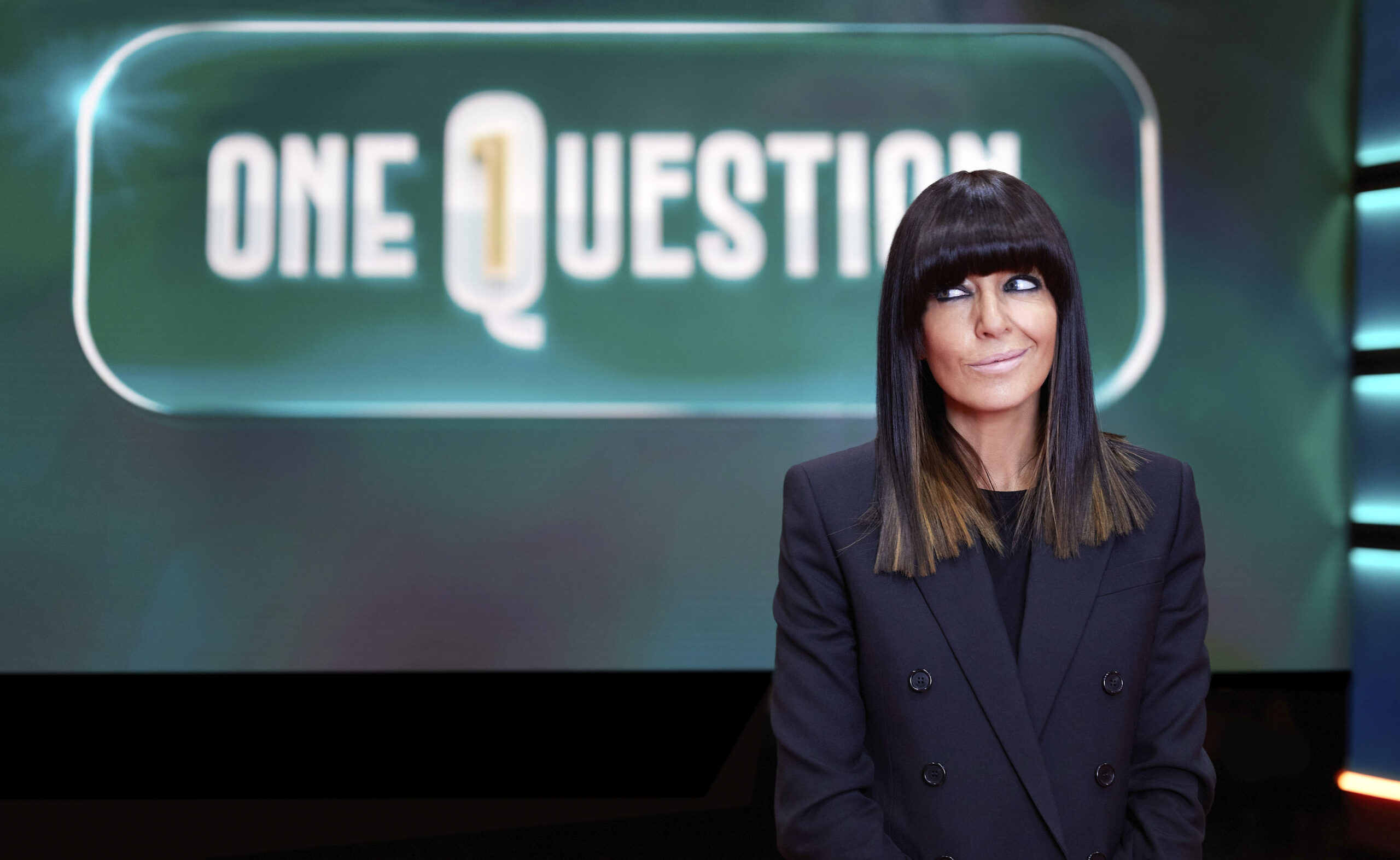 Claudia Winkleman, host of One Question poses with the show's logo