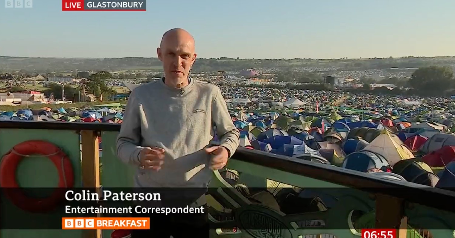 Colin Paterson stood in front of thousands of tents at Glastonbury Festival on BBC Breakfast today