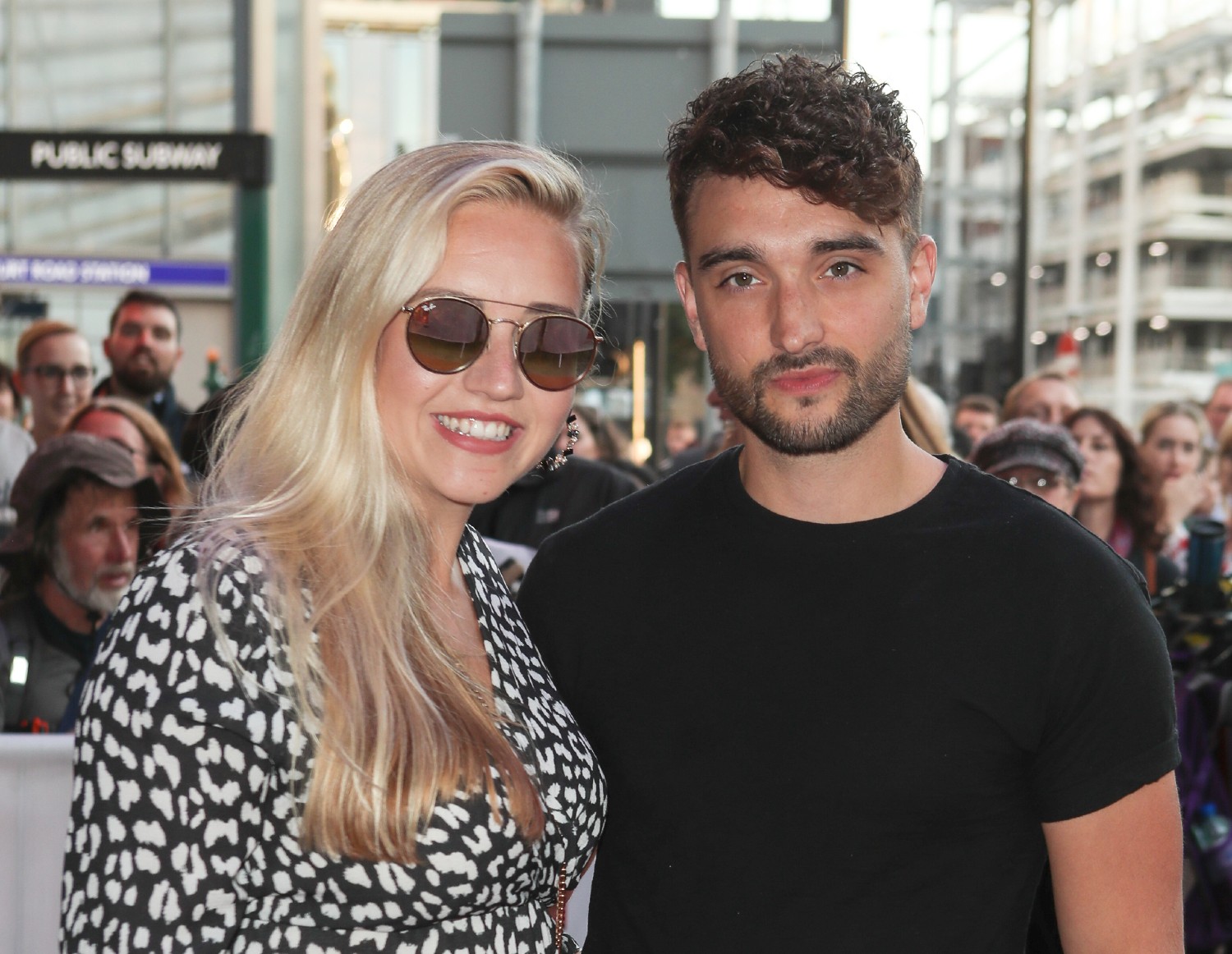 Tom Parker and his wife Kelsey smiling on the red carpet