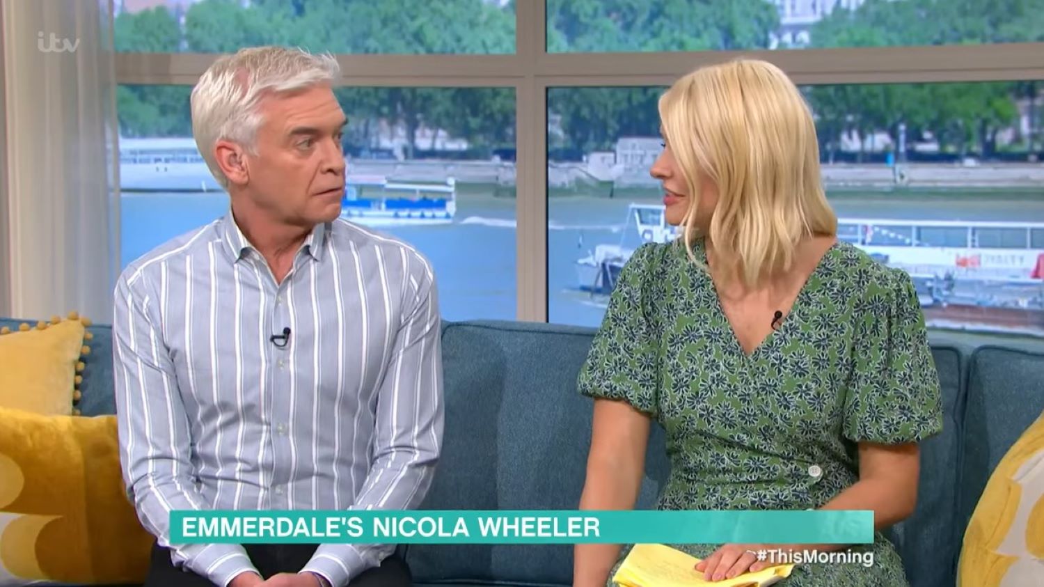 Phil and Holly look at each other nervously on the This Morning sofa