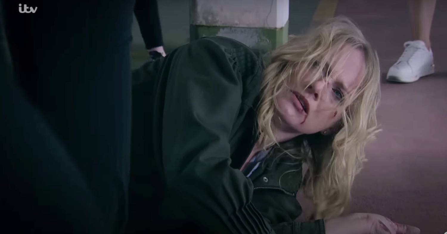 Nicola struggles on the floor of the car park