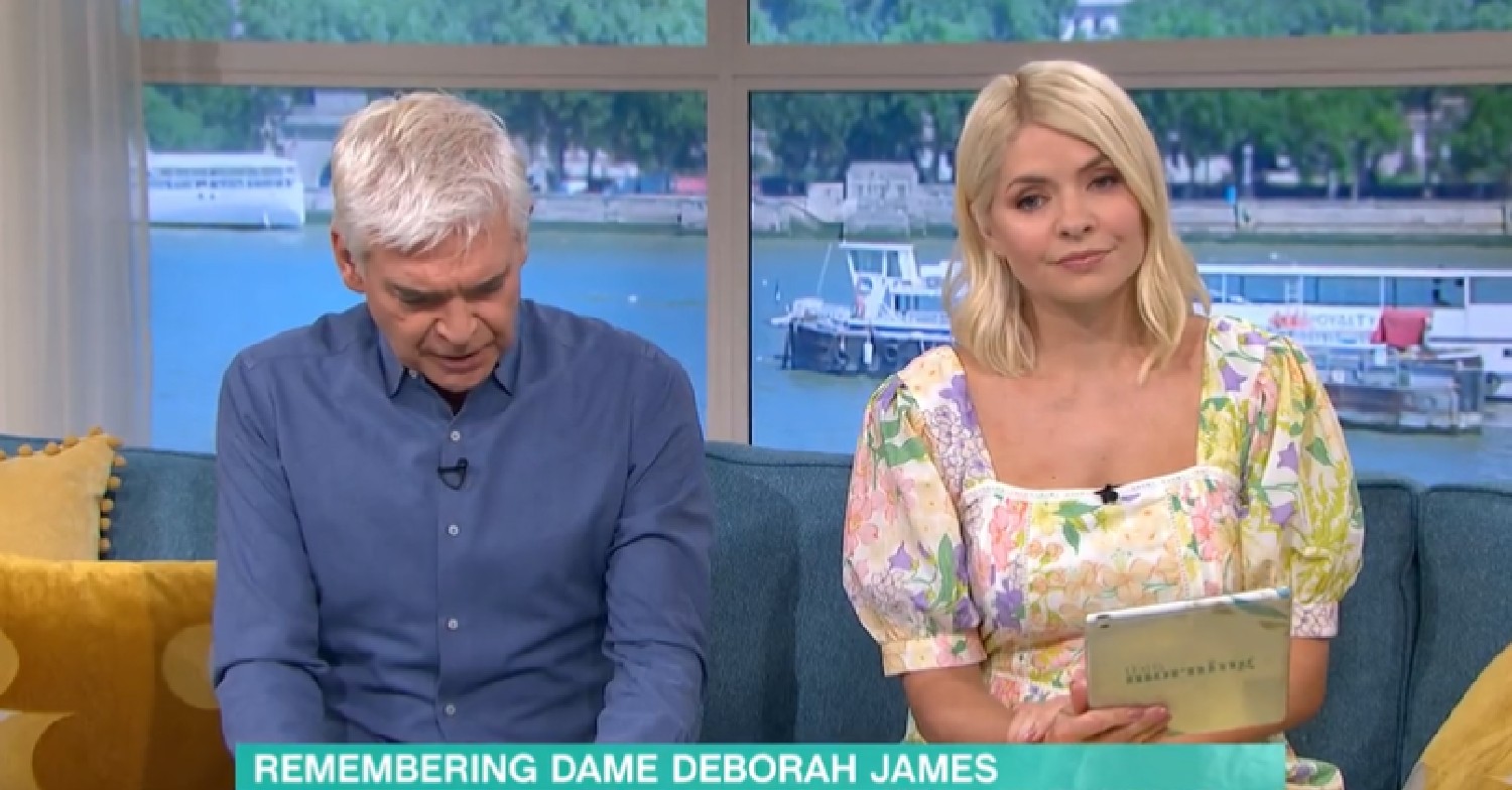 Phillip Schofield looking down as Holly Willoughby looks at camera on This Morning