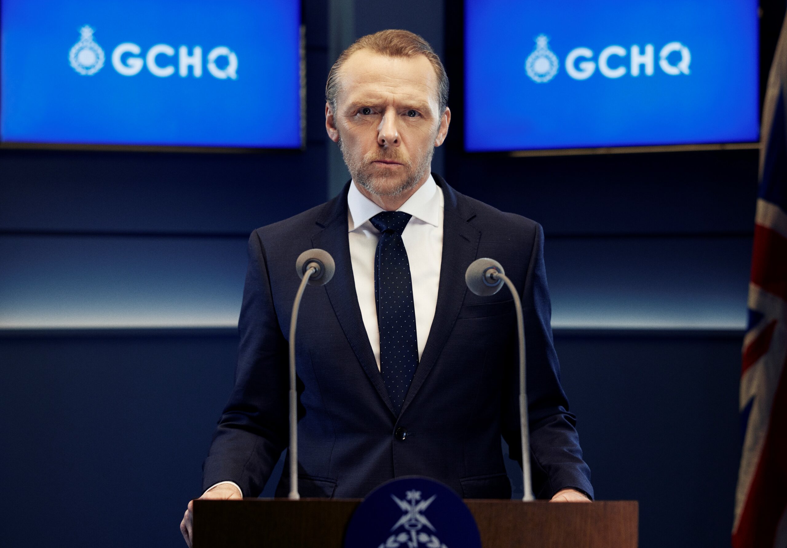 Simon Pegg as Danny in a press conference in the Undeclared War?