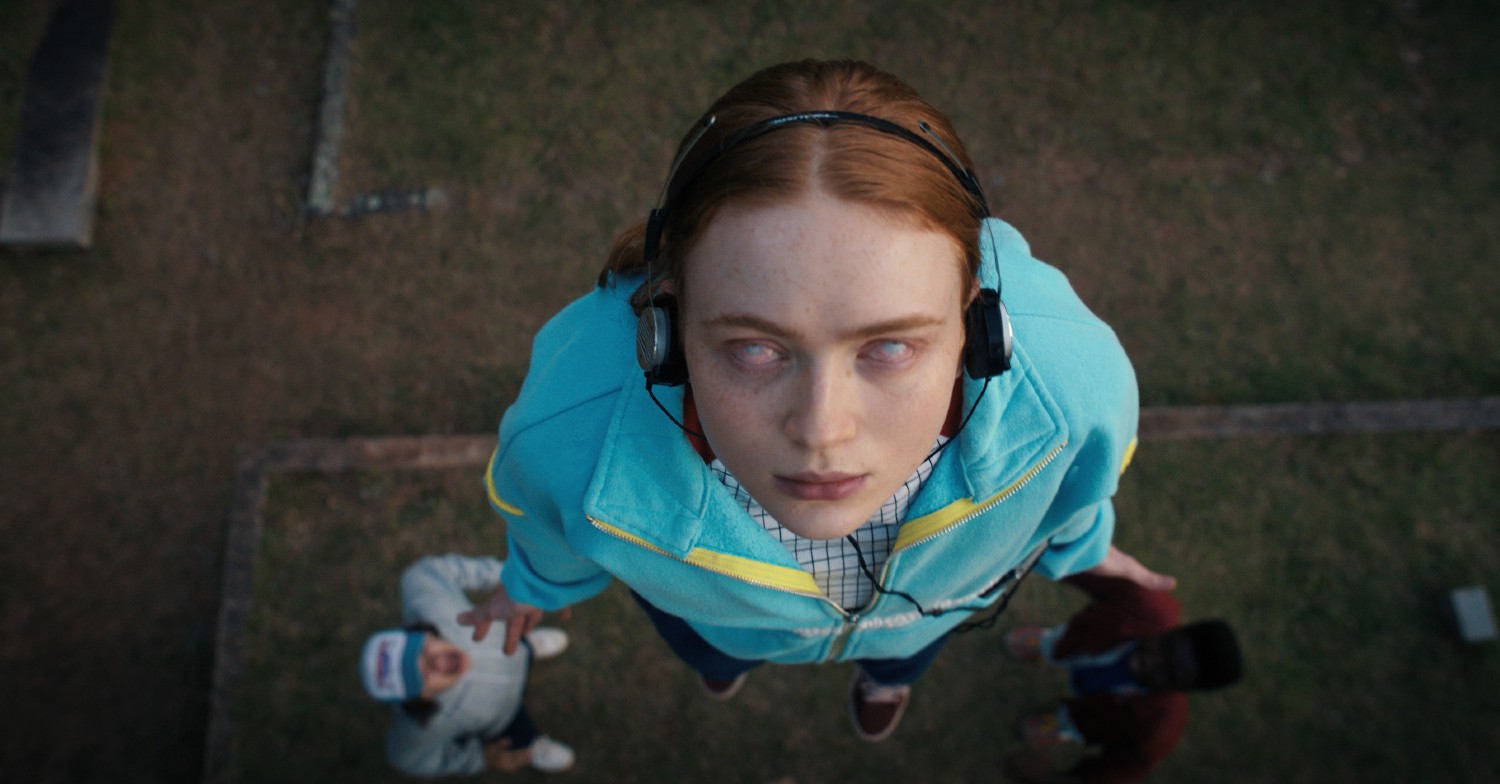 Max floating above the ground with pale white eyes in Stranger Things season 4