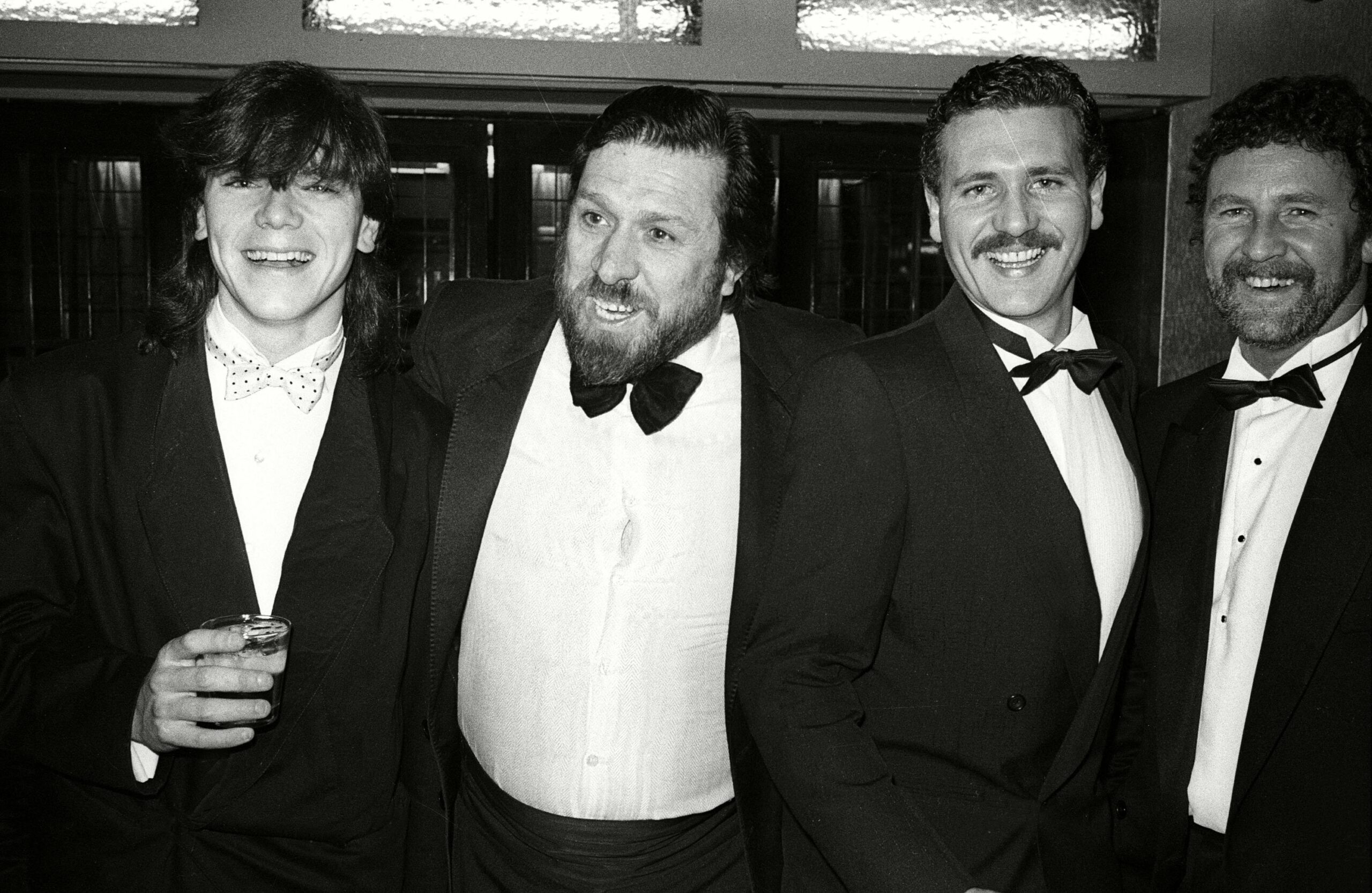 Simon O'Brien and his Brookside co-stars smiling in suits