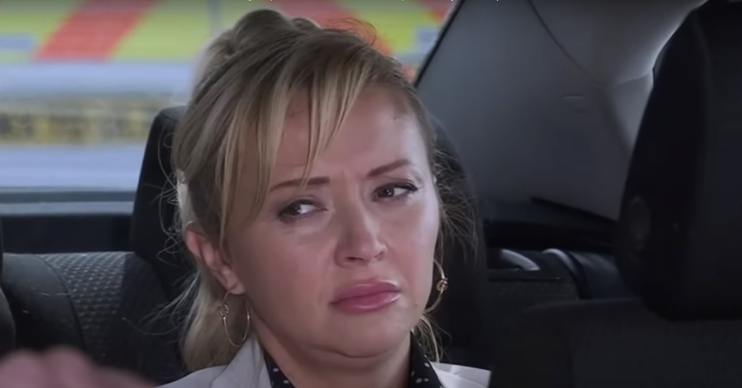 Nicky looking sad inside taxi on Coronation Street