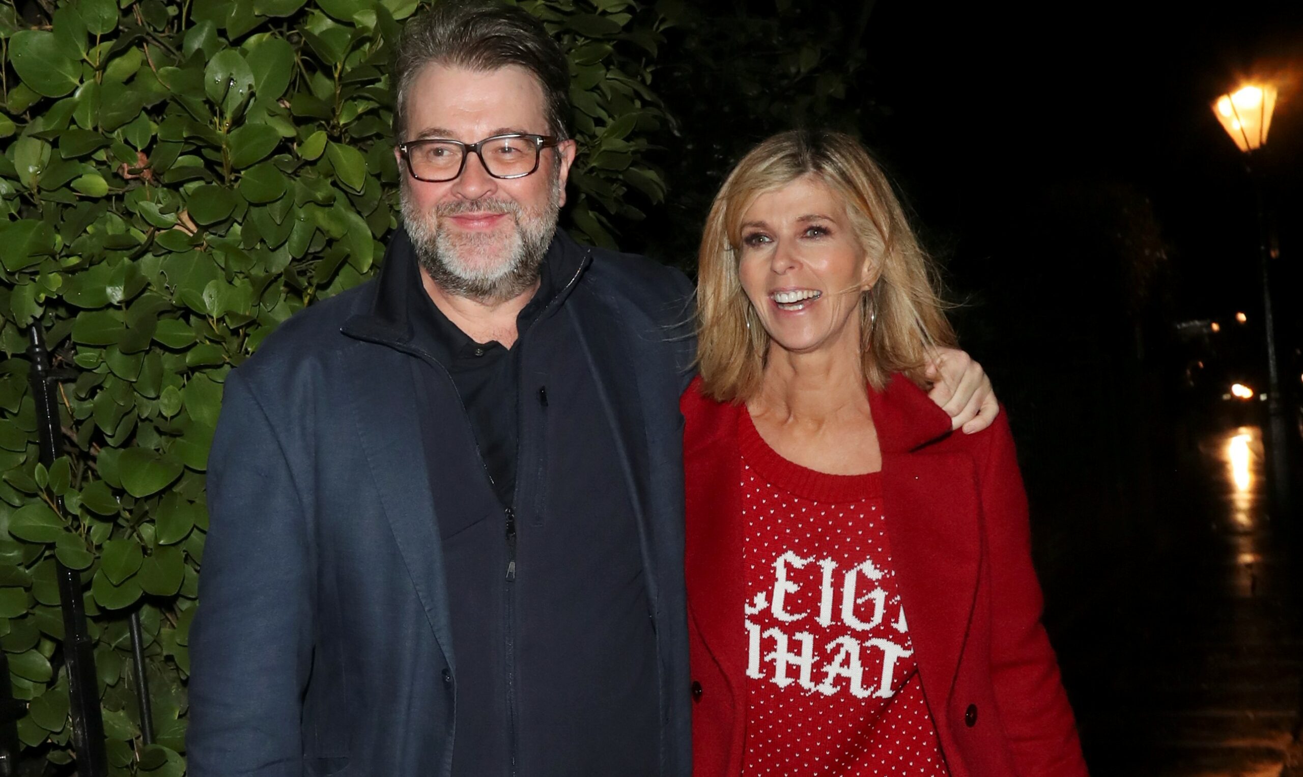 Derek Draper and Kate Garraway smile outside Piers Morgan's Christmas party in 2019