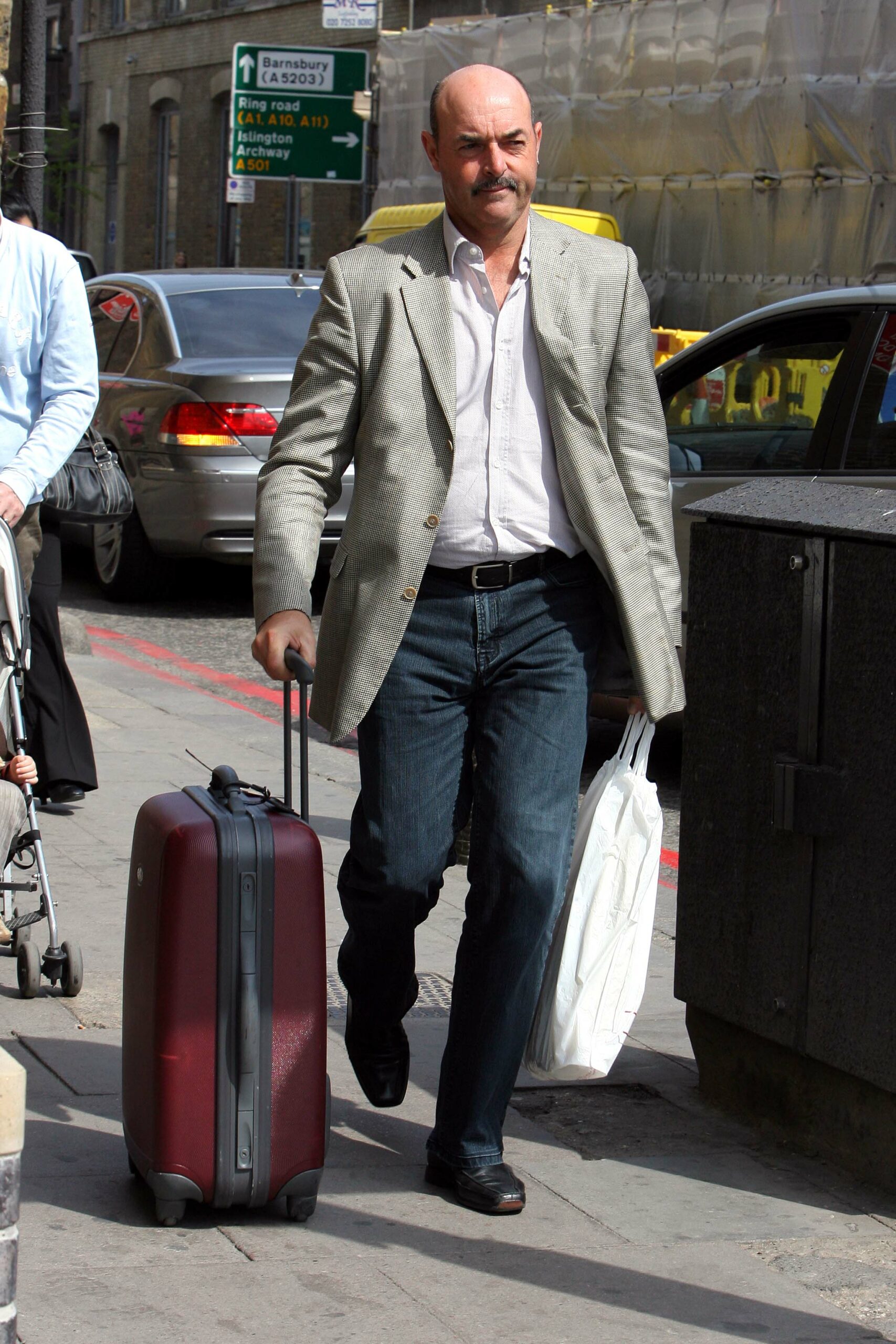 Bruce Grobbelaar, rumoured to be part of the Strictly 2022 line-up, walking down the street with suitcase