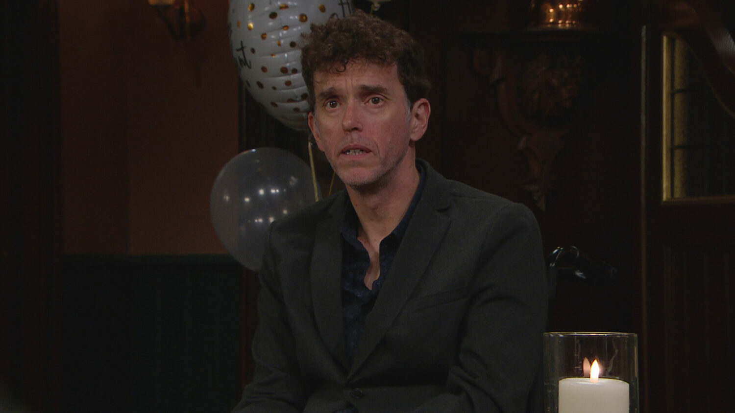 Marlon Dingle looks worried at his engagement party in Emmerdale