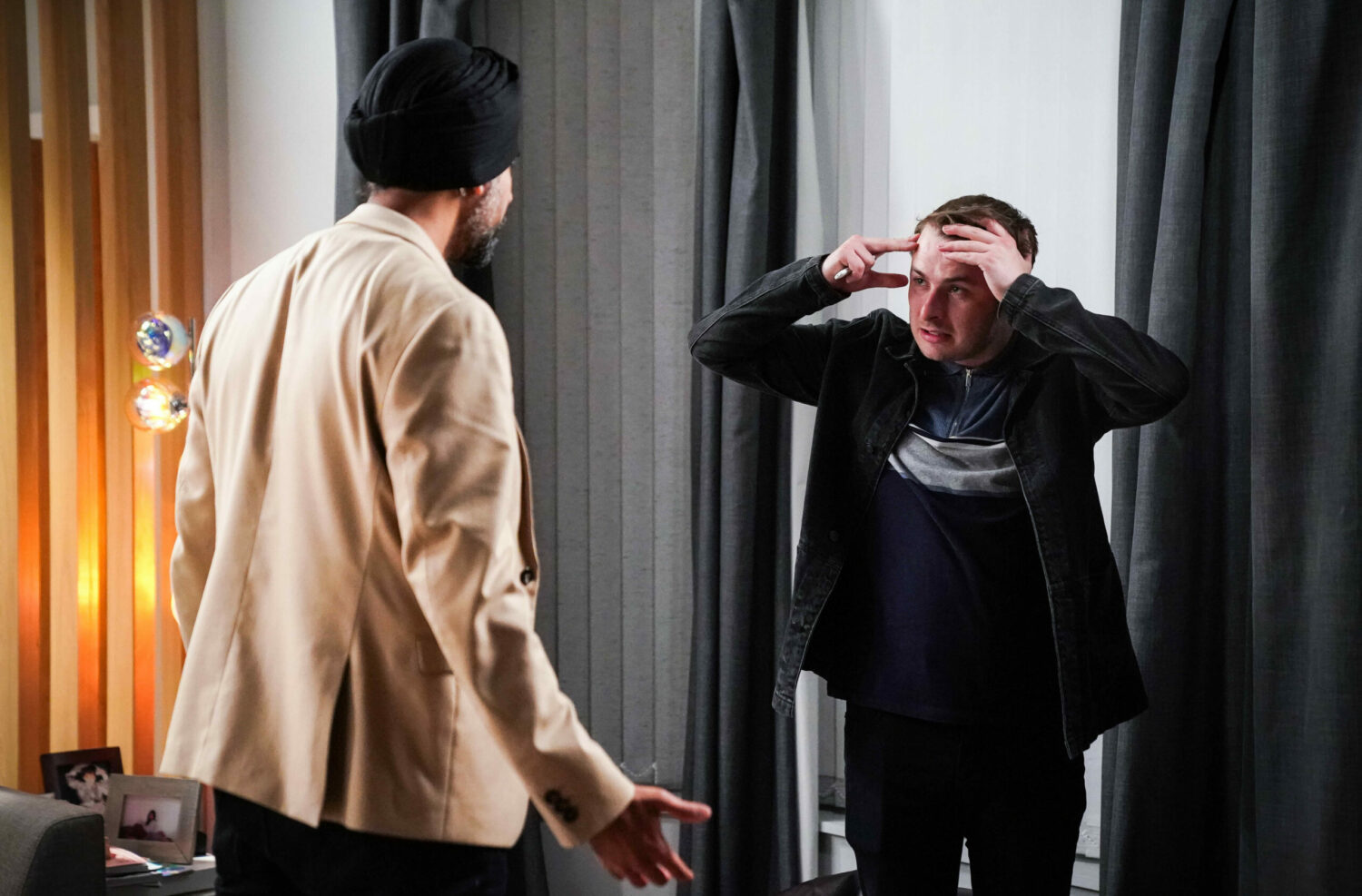 EastEnders Ben holds his head as he talks to Kheerat