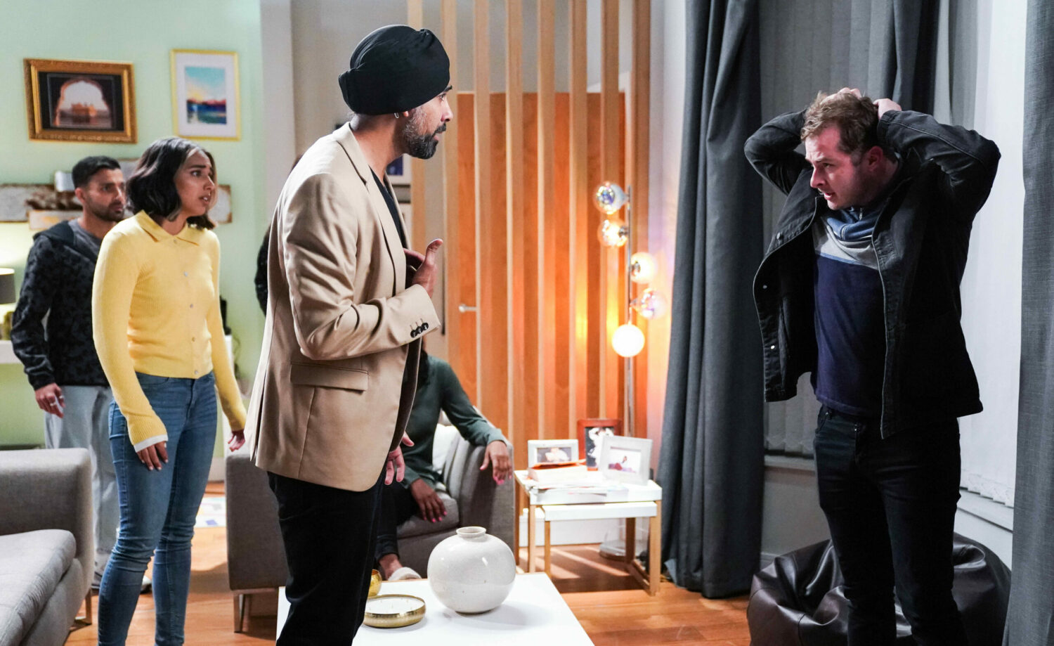 EastEnders Ben holds his head as he talks to Kheerat