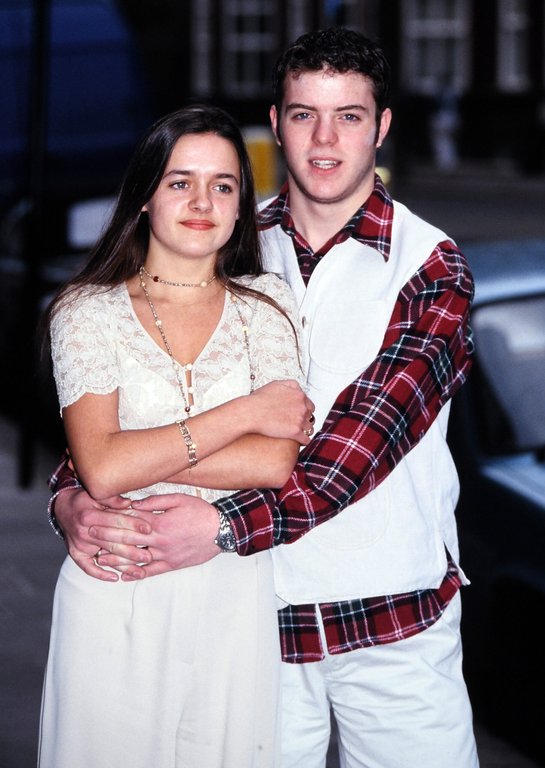 Two actors from Brookside cuddling and smiling
