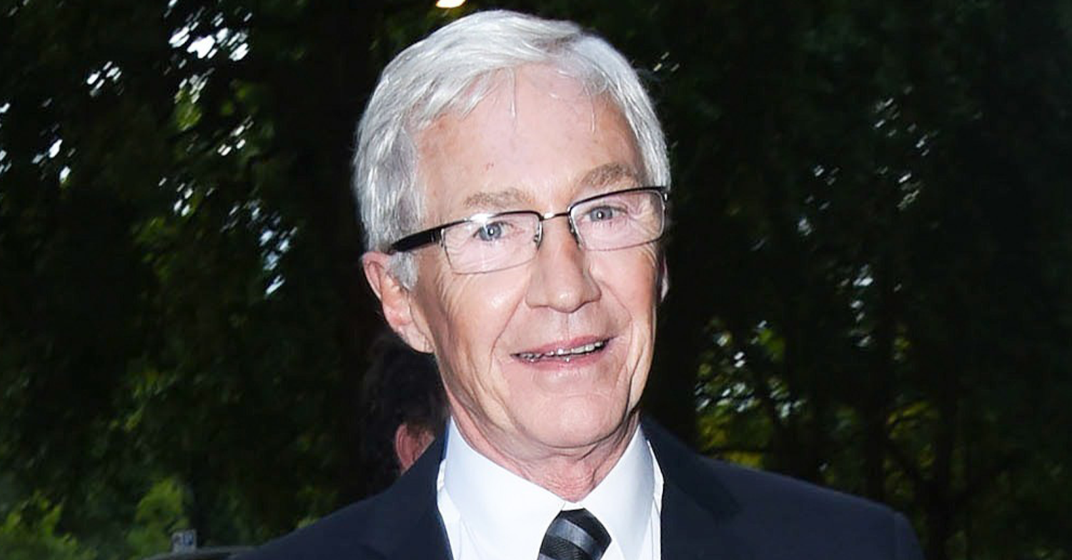 Paul O'Grady smiling wearing a suit