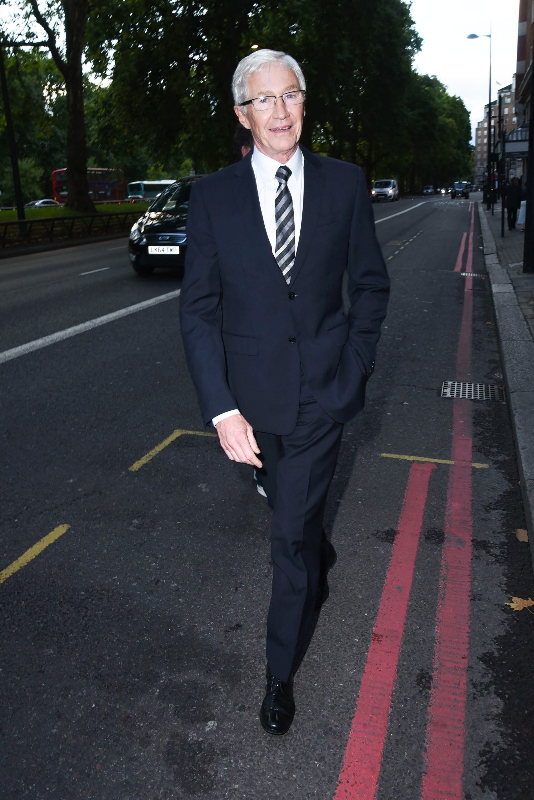 Paul O'Grady smiling wearing a suit
