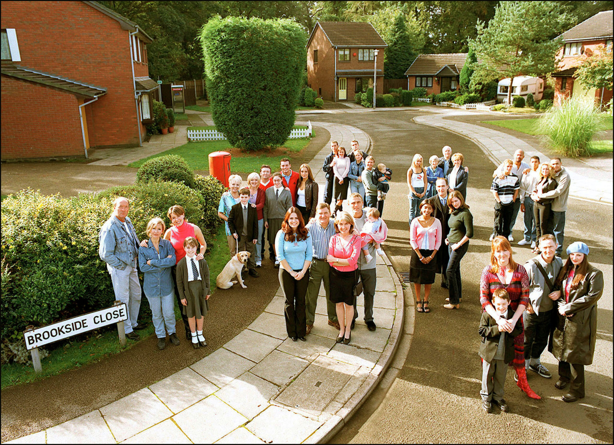 The characters from Brookside posing outside in the close