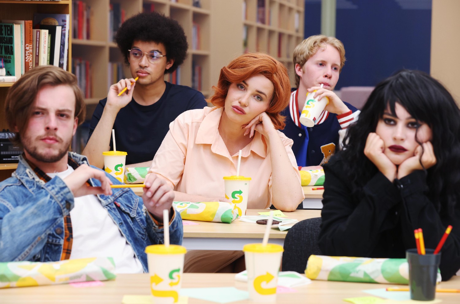 Amy Hart dressed as Molly Ringwald and eating a subway 