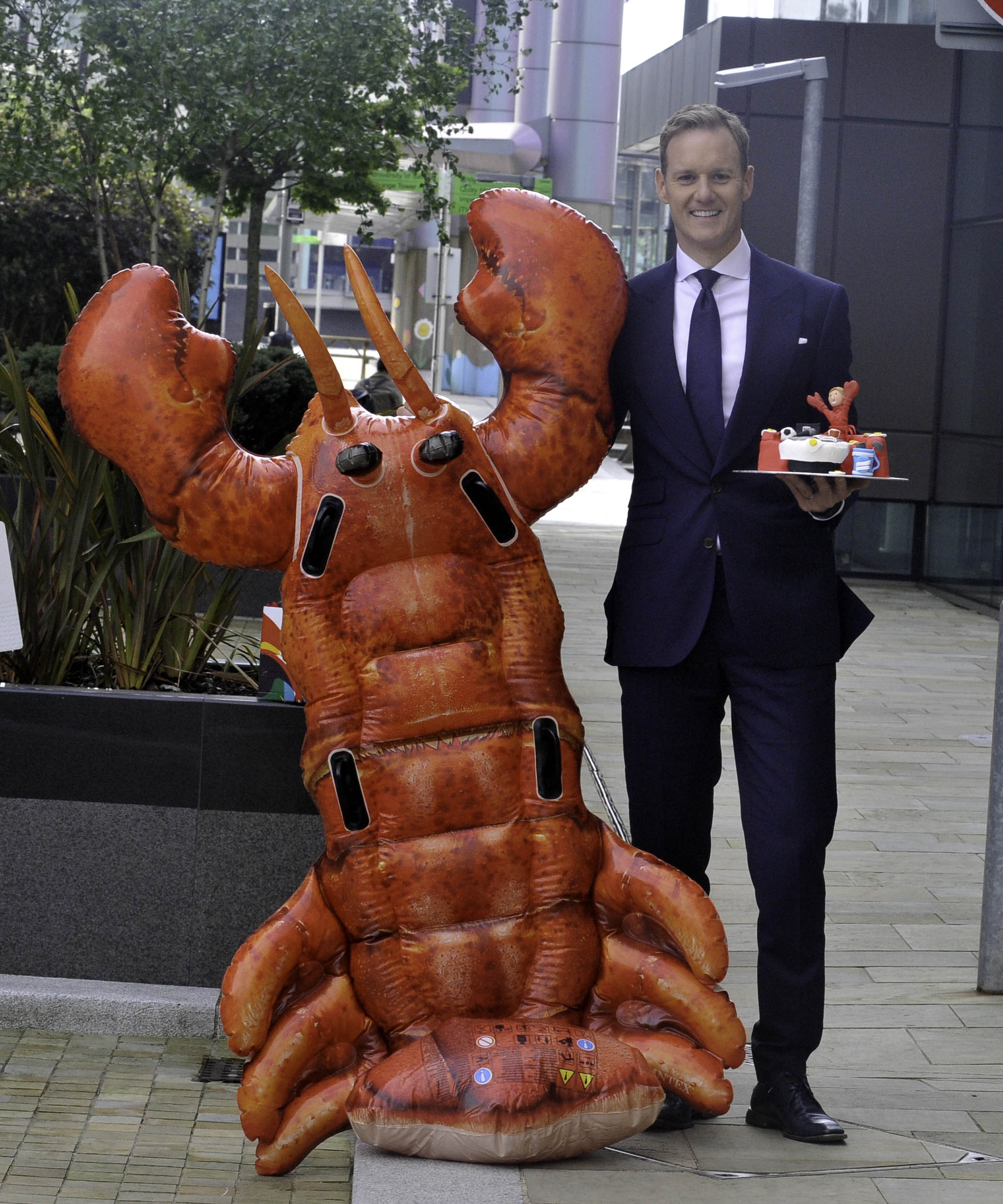 Dan Walker Poses Up With A Lobster And A Leaving Cake For His Last Day On BBC Breakfast Studios