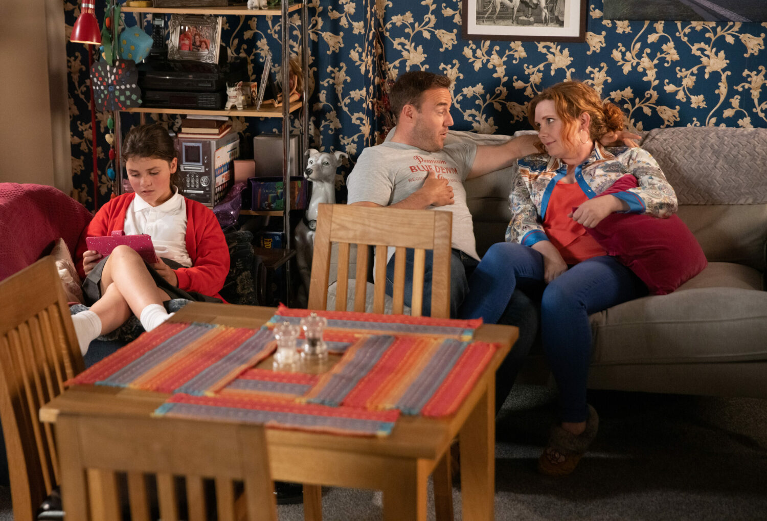 Coronation Street Hope looks at her tablet as Tyrone and Fiz talk