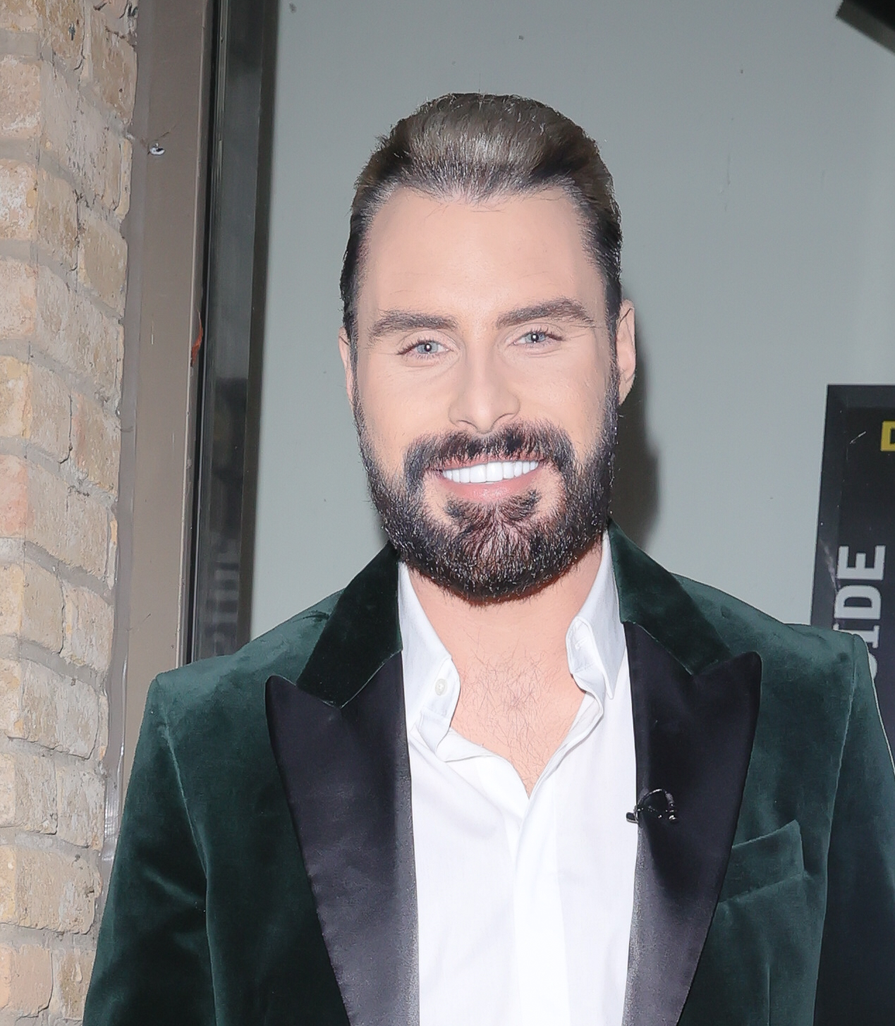 Rylan Clark looks dapper in a green jacket flashing his blonde highlights 