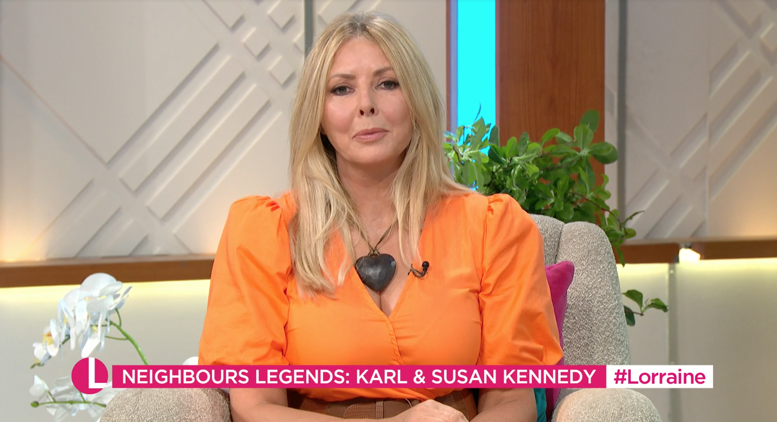 Carol Vorderman presenting Lorraine wearing orange