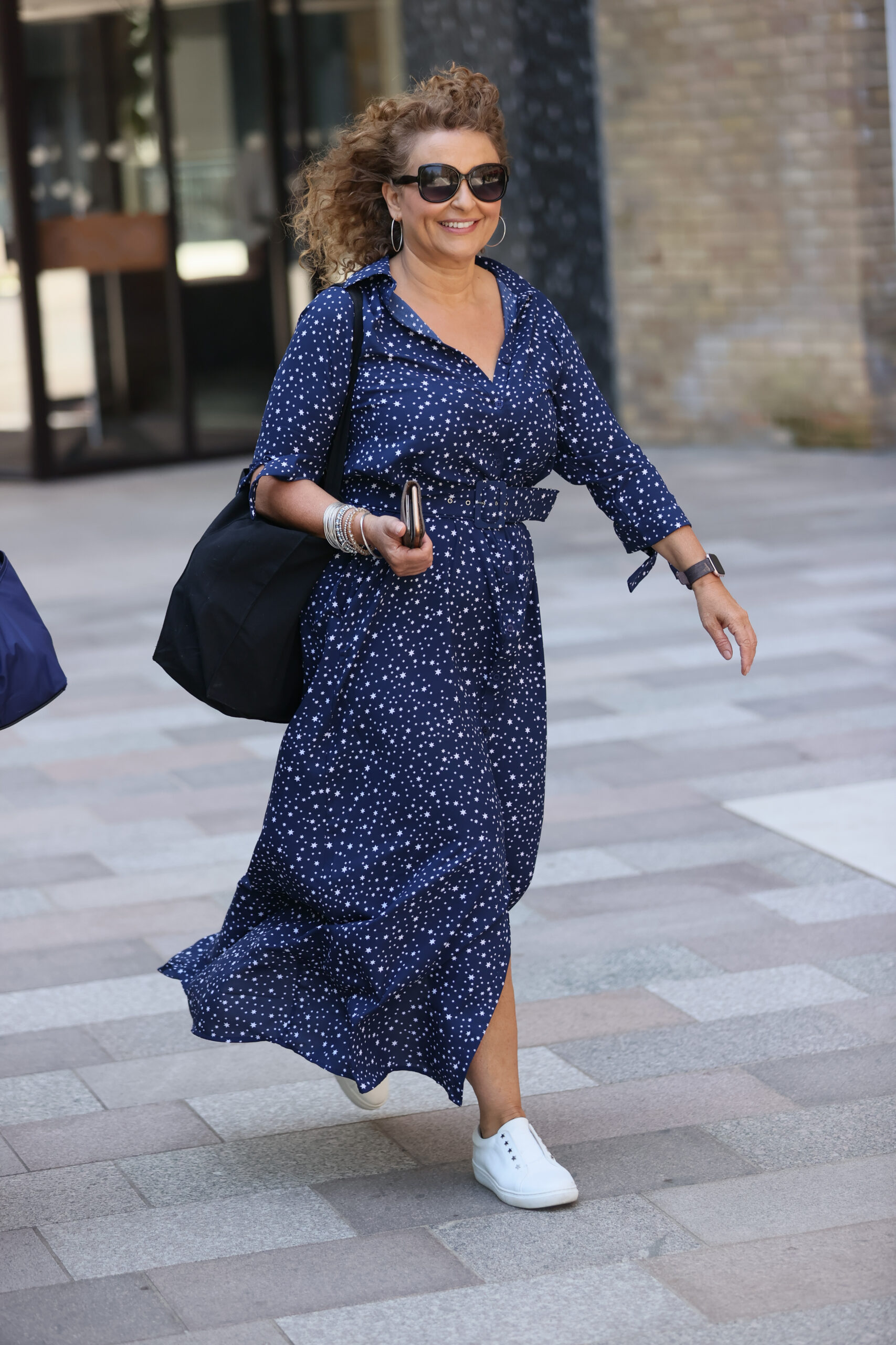 Nadia Sawalha smiles as she leaves Loose Women studios
