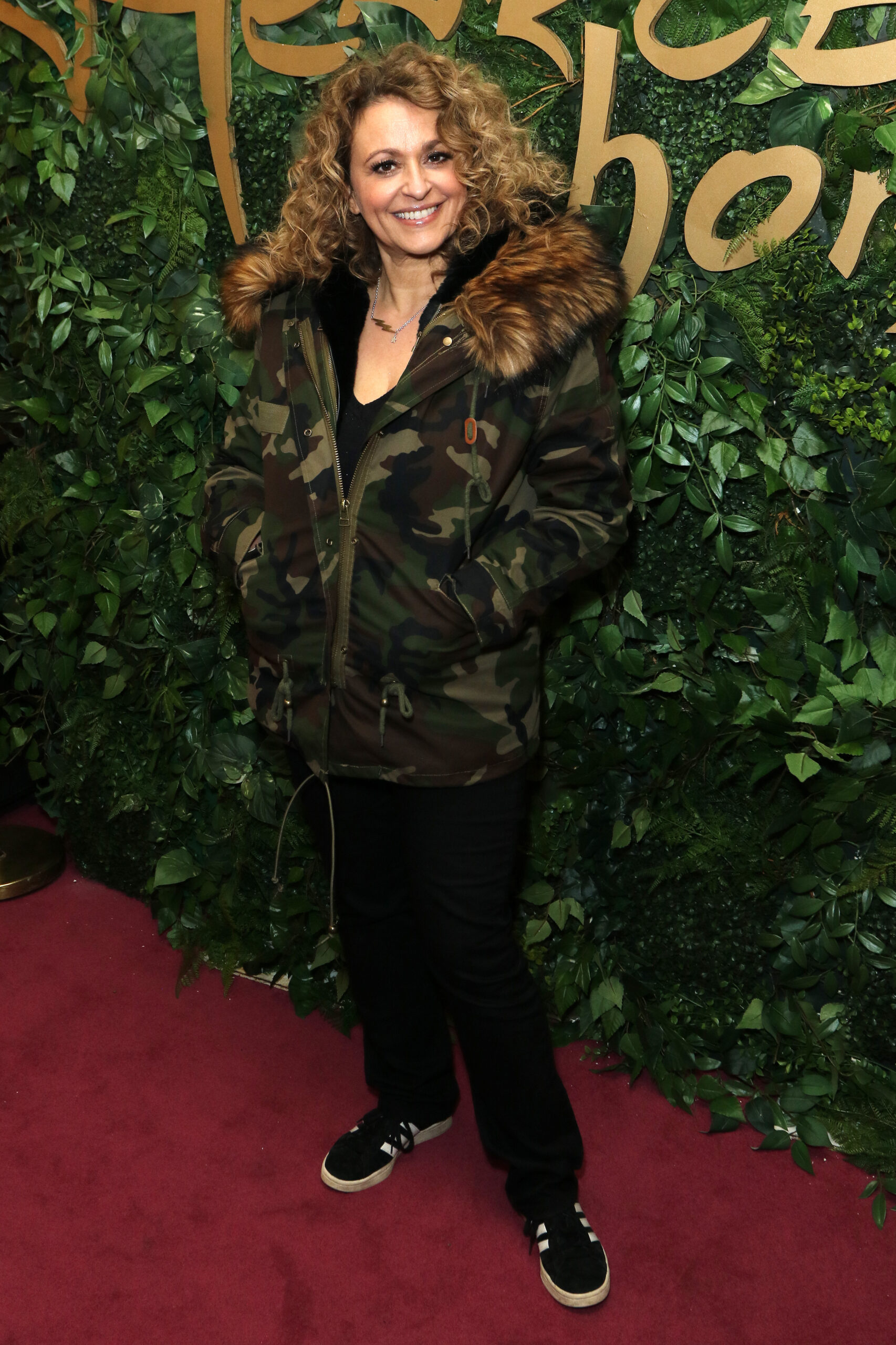 Nadia Sawalha smiling in parka coat at event
