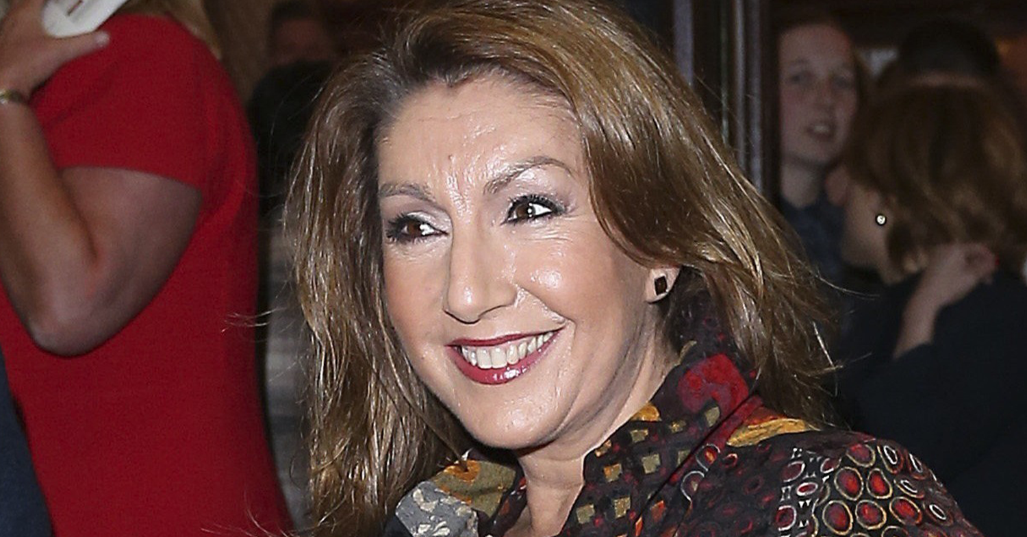 Jane McDonald smiling outside a theatre