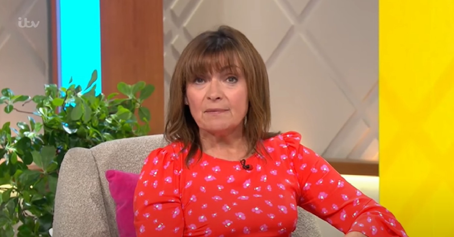 Lorraine Kelly looks at the camera in red dress on her show