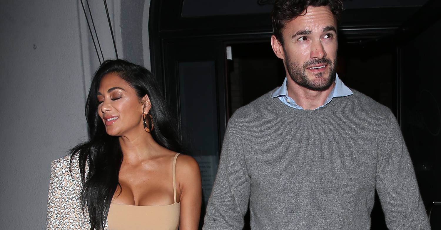 Nicole Scherzinger and Thom Evans look in different directions