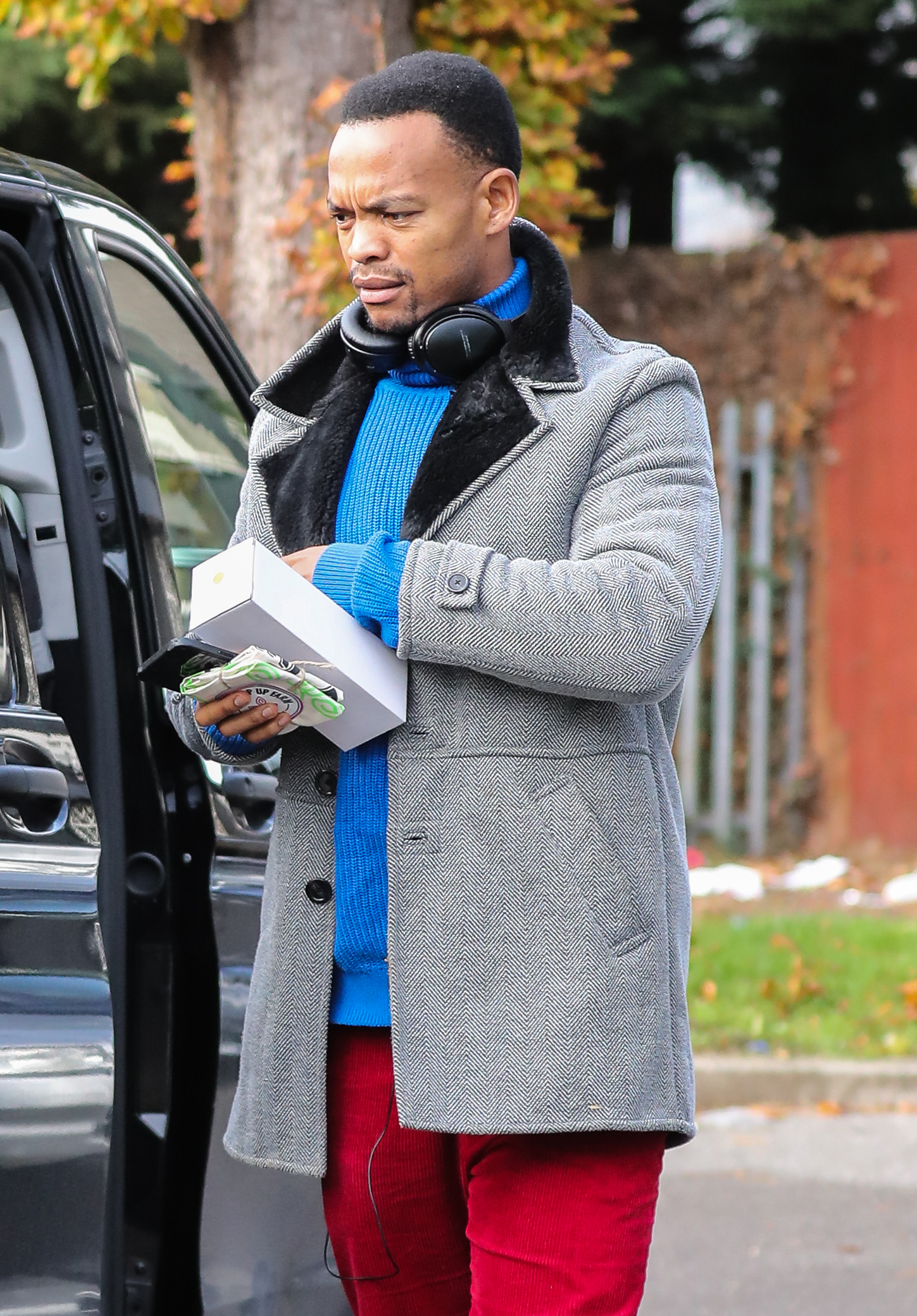 Johannes Radebe in a grey coat outside Strictly studios