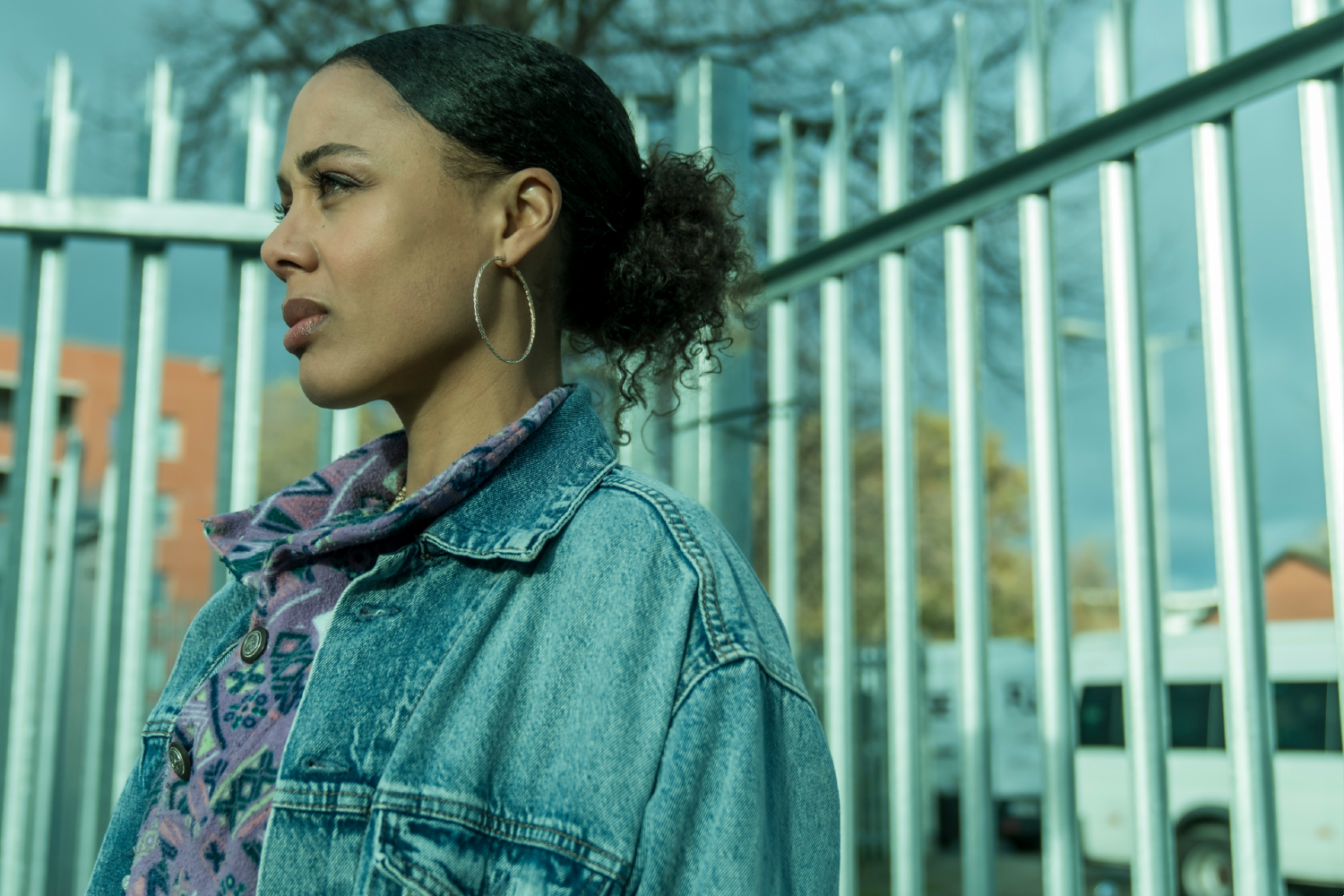 Nina Toussaint-White leaning against a metal fence on Witness Number 3