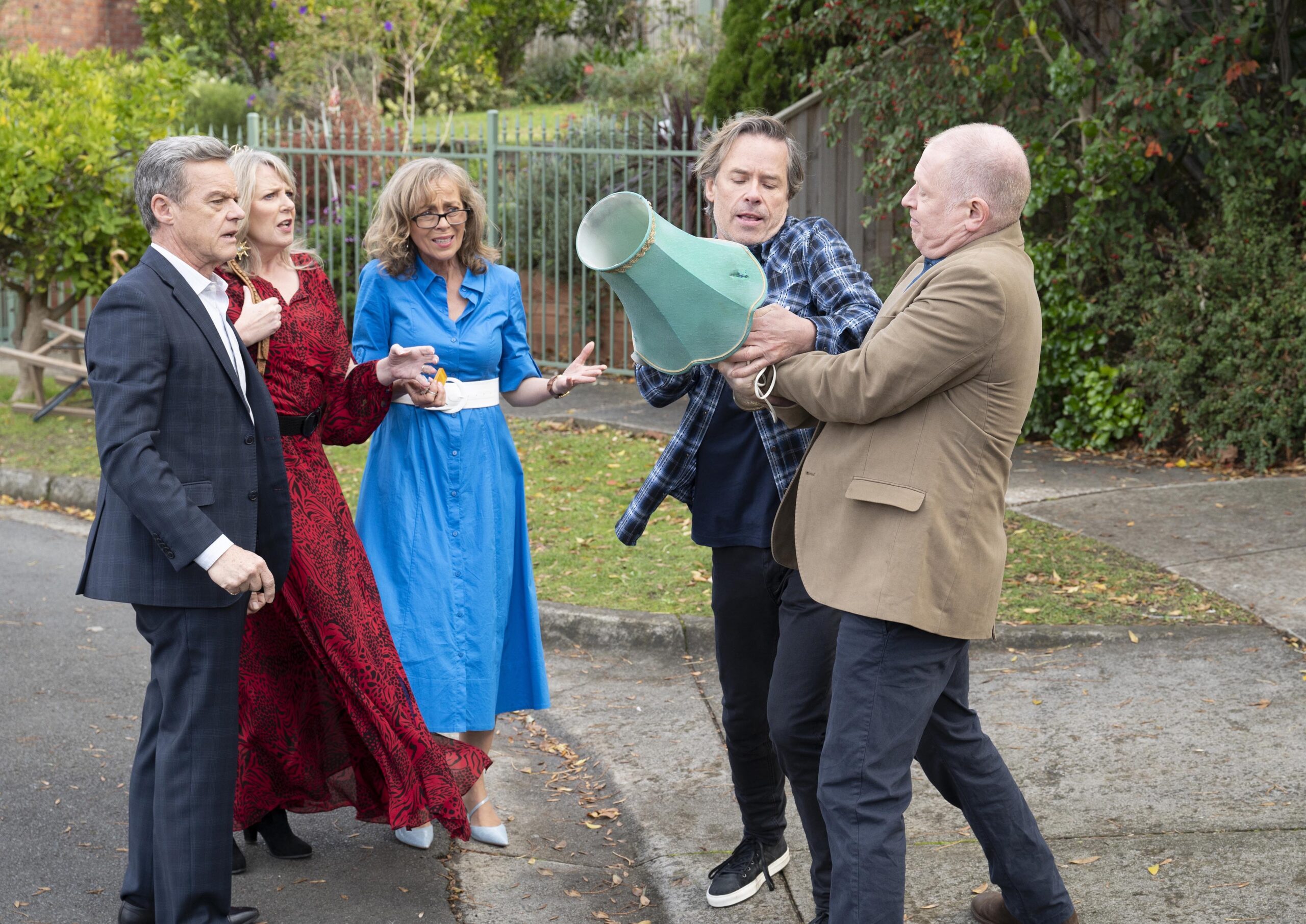Neighbours Paul Melanie and Jane watch on as Mike and Clive fight over a lamp